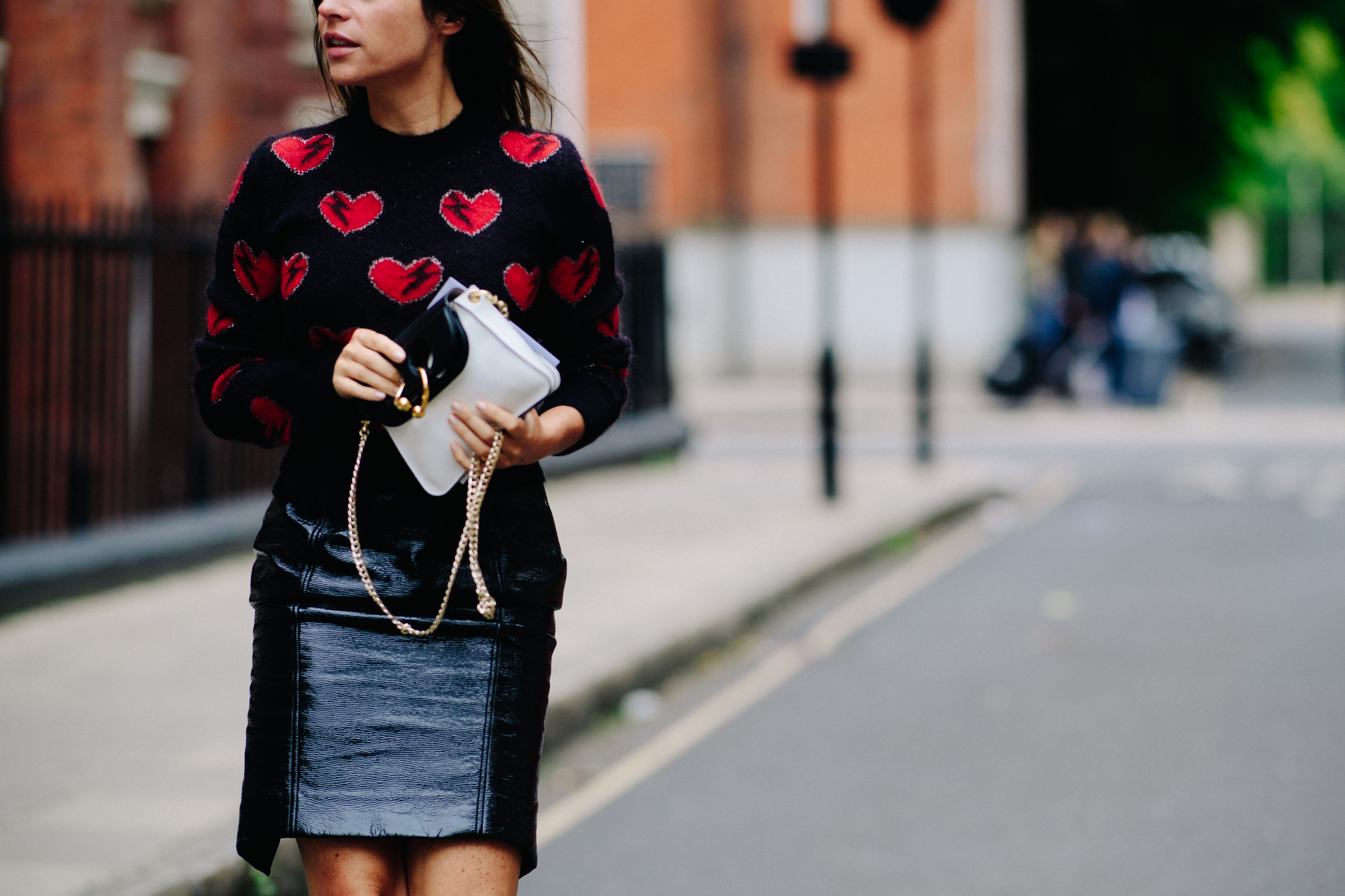 Woman wearing sweater with broken hearts