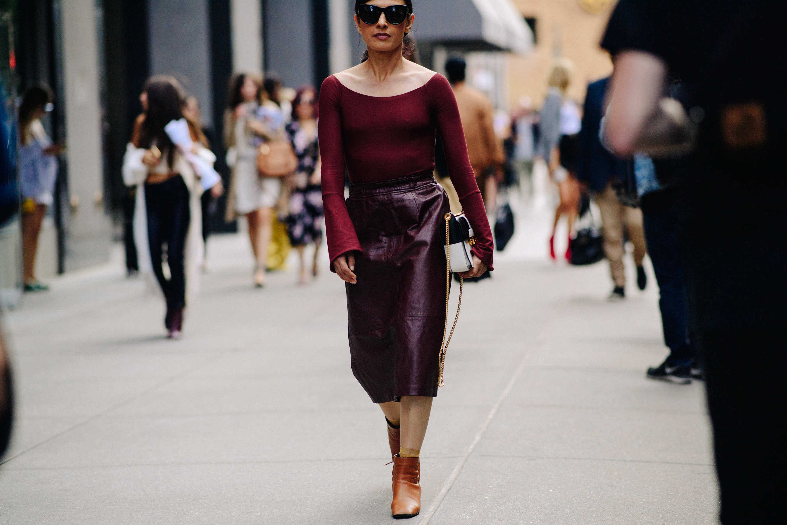 Woman wearing burgundy leather skirt