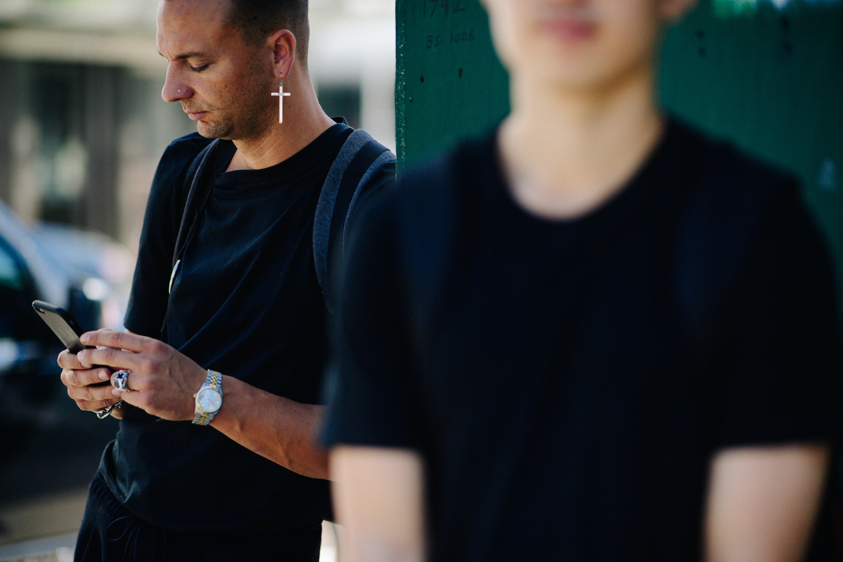 French photographer wearing cross earring