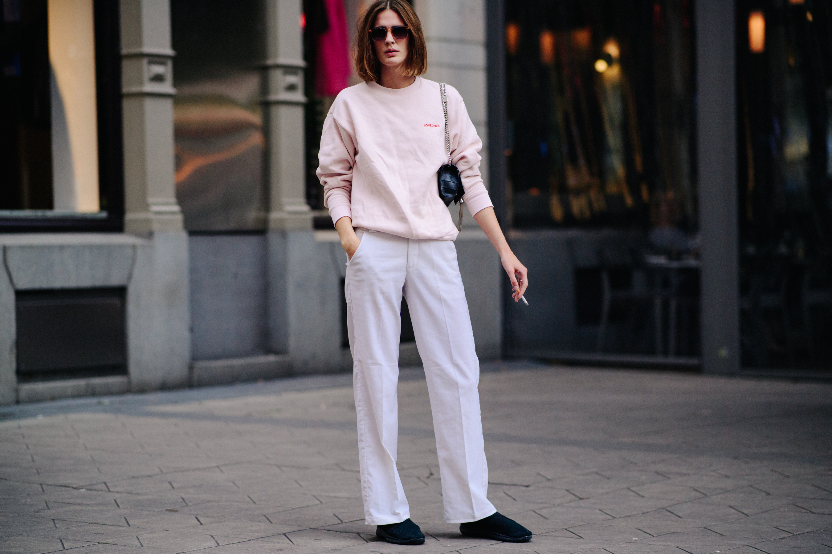 Model wearing white pants and sweater
