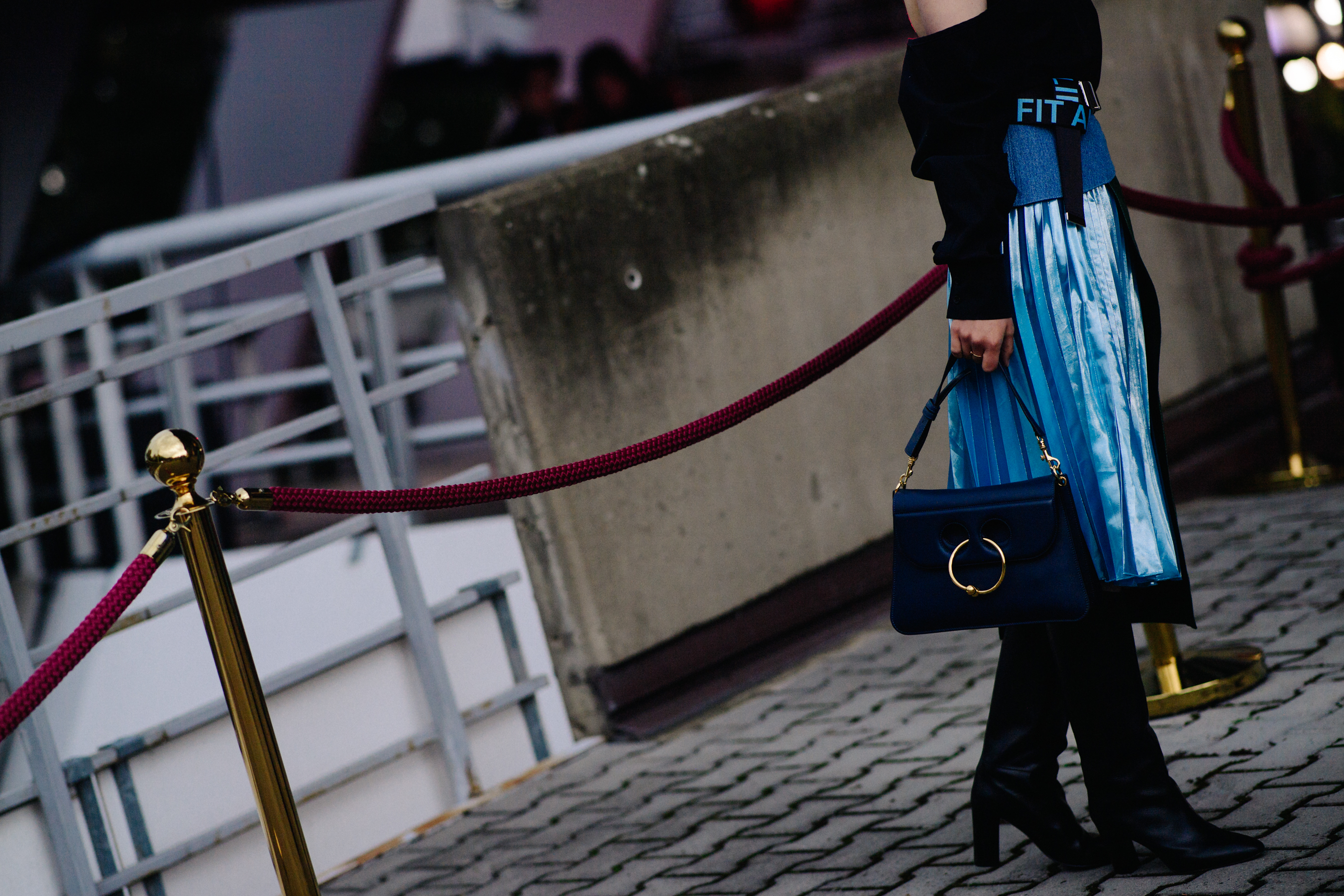 Girl wearing blue J.W.Anderson bag
