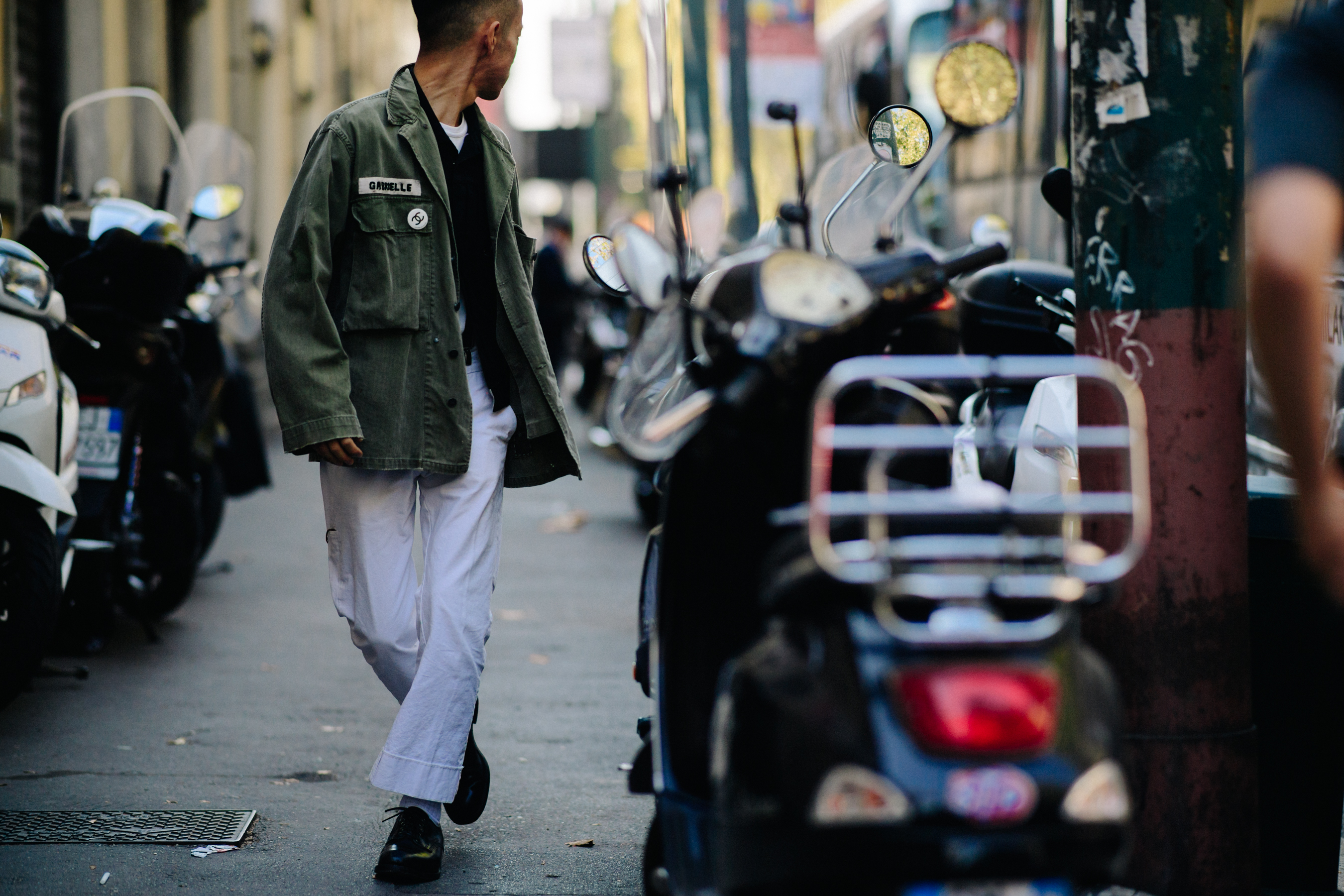 Man wearing military jacket and white pants