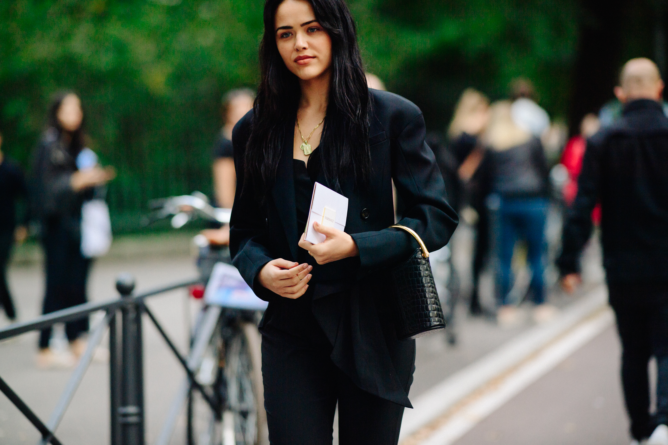 Blogger wearing black suit with black hair