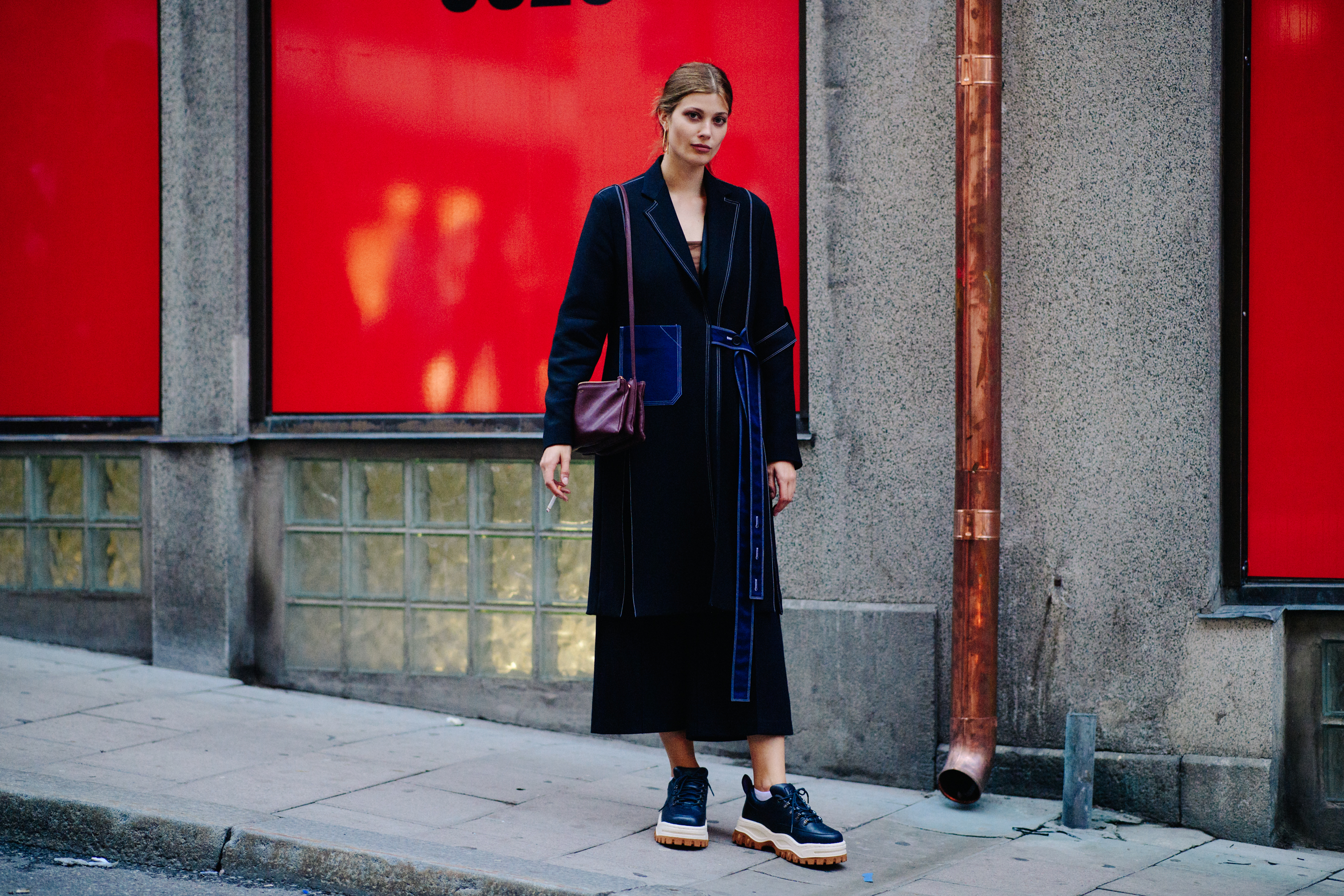 German model and photograhper wearing black coat
