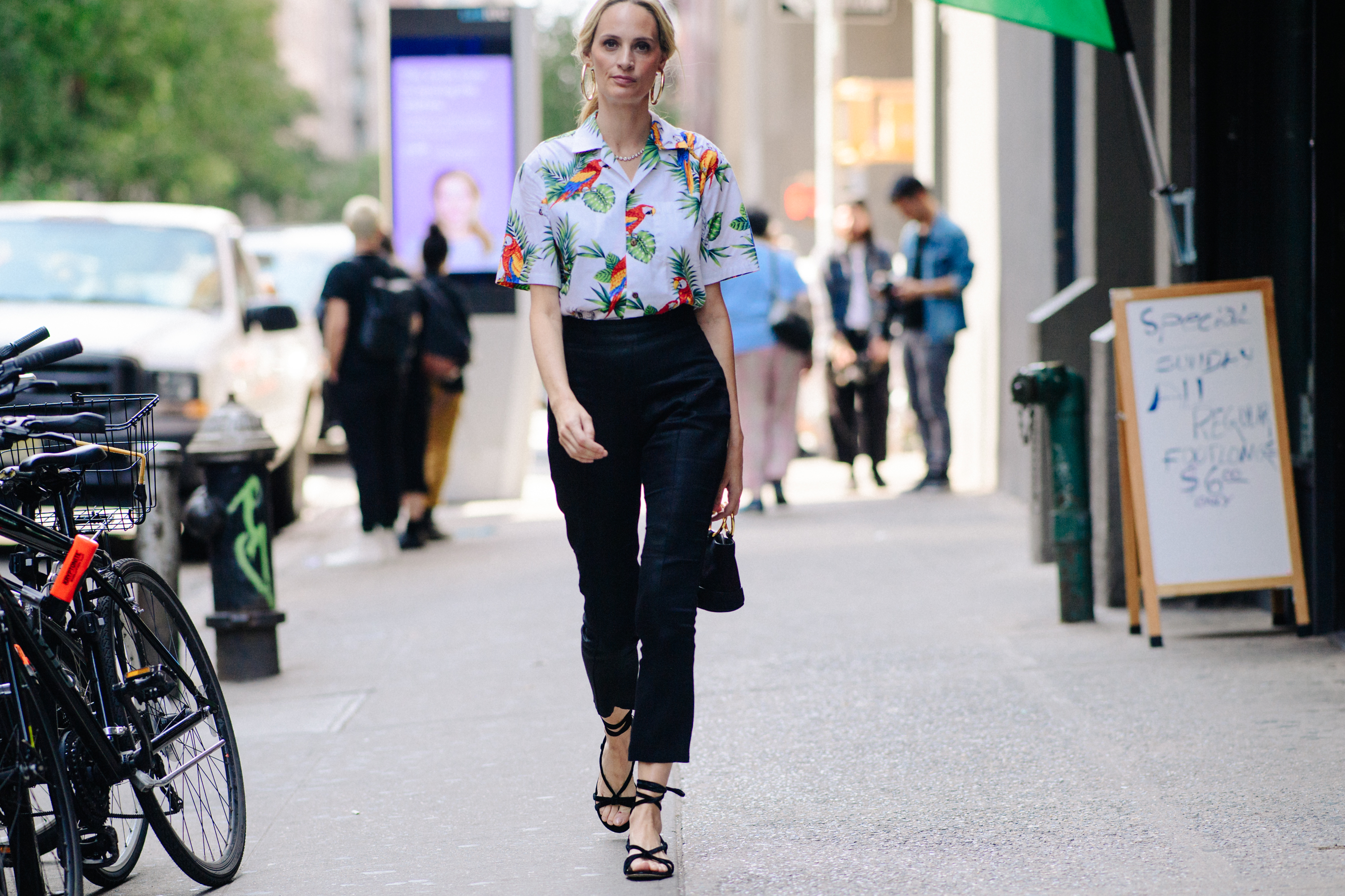 Woman wearing Hawaii shirt and black pants