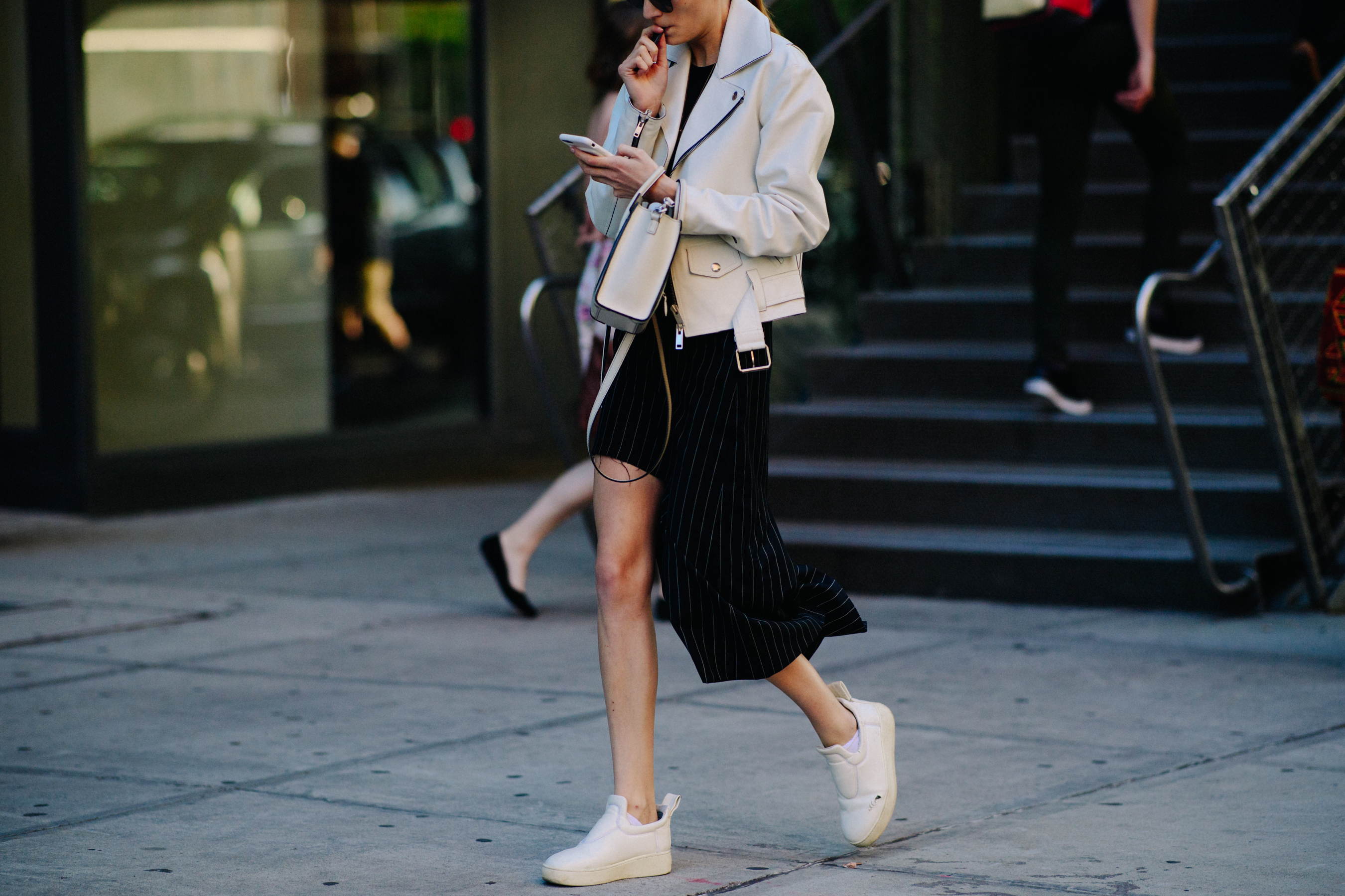 Woman wearing white Celine sneakers
