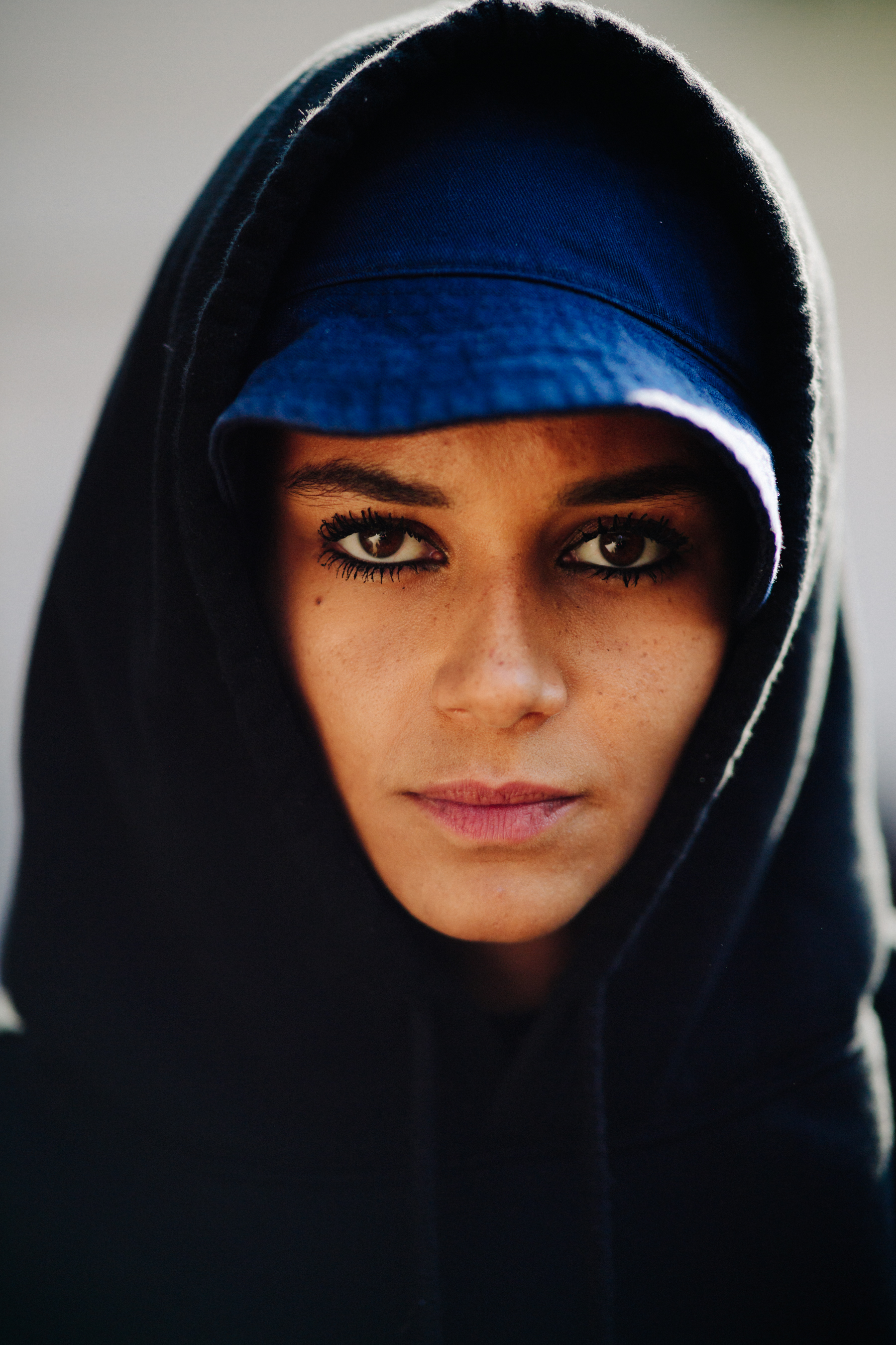 Model wearing panama hat and a hoodie