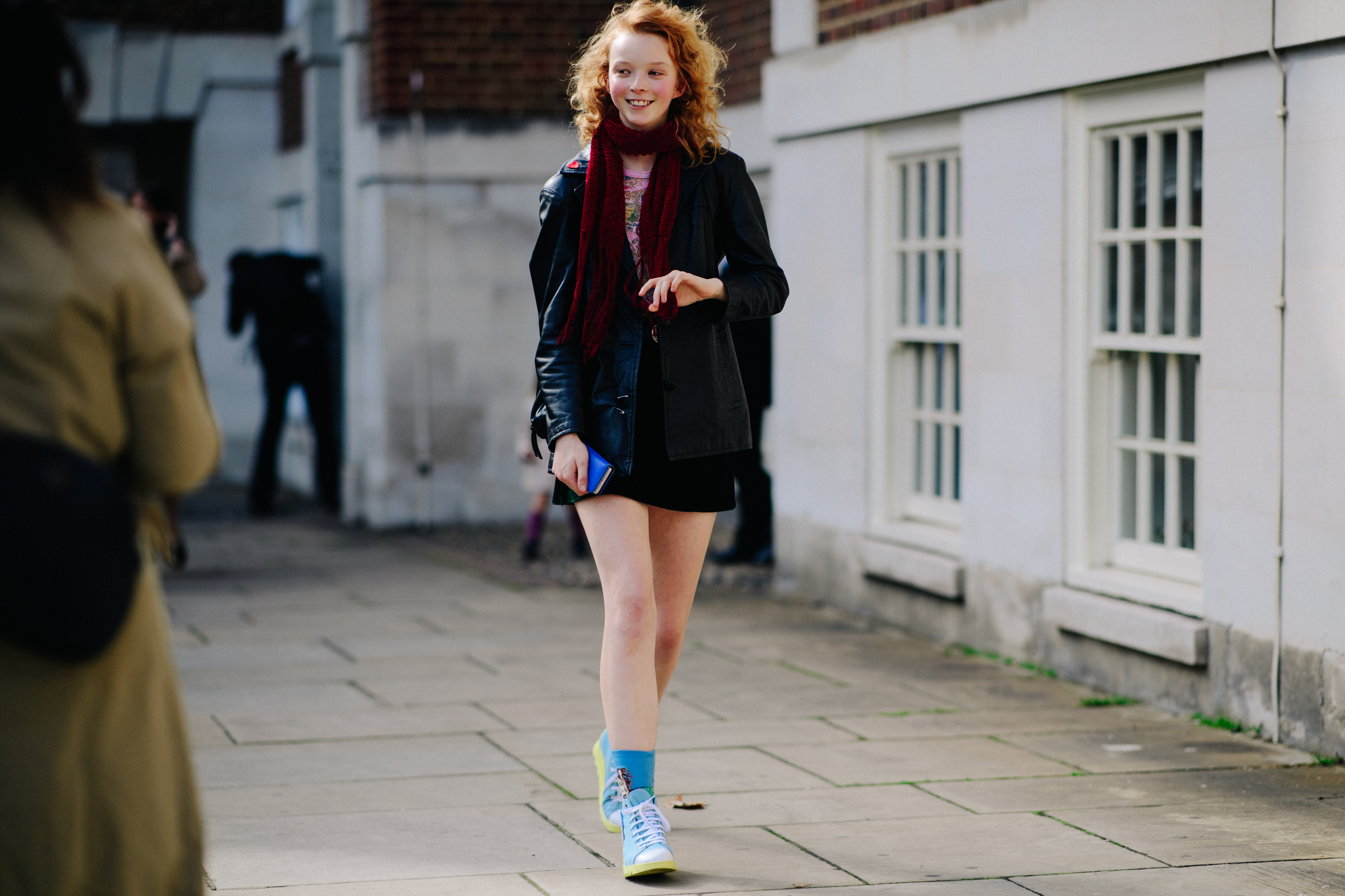 Model with red hair wearing mini skirt