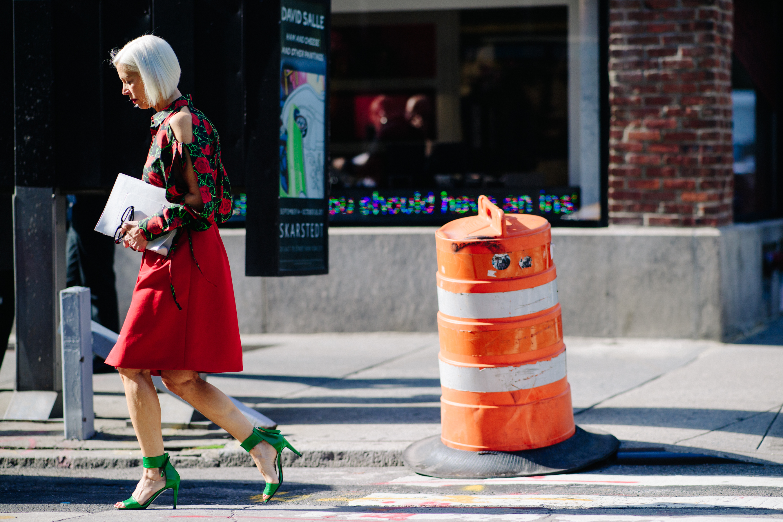 Woman wearing red skirt and green shoes
