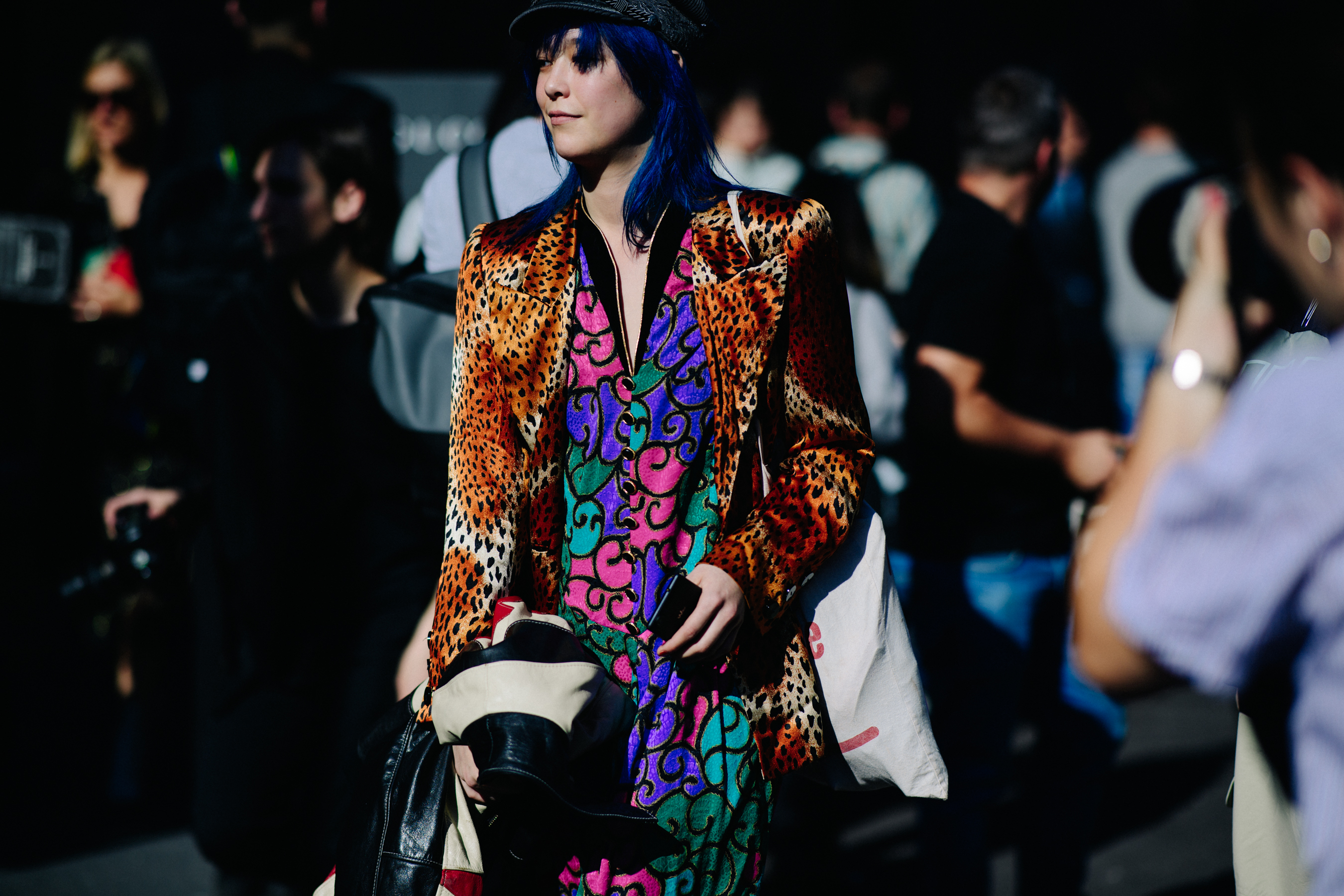 Woman with blue hair and animal print jacket