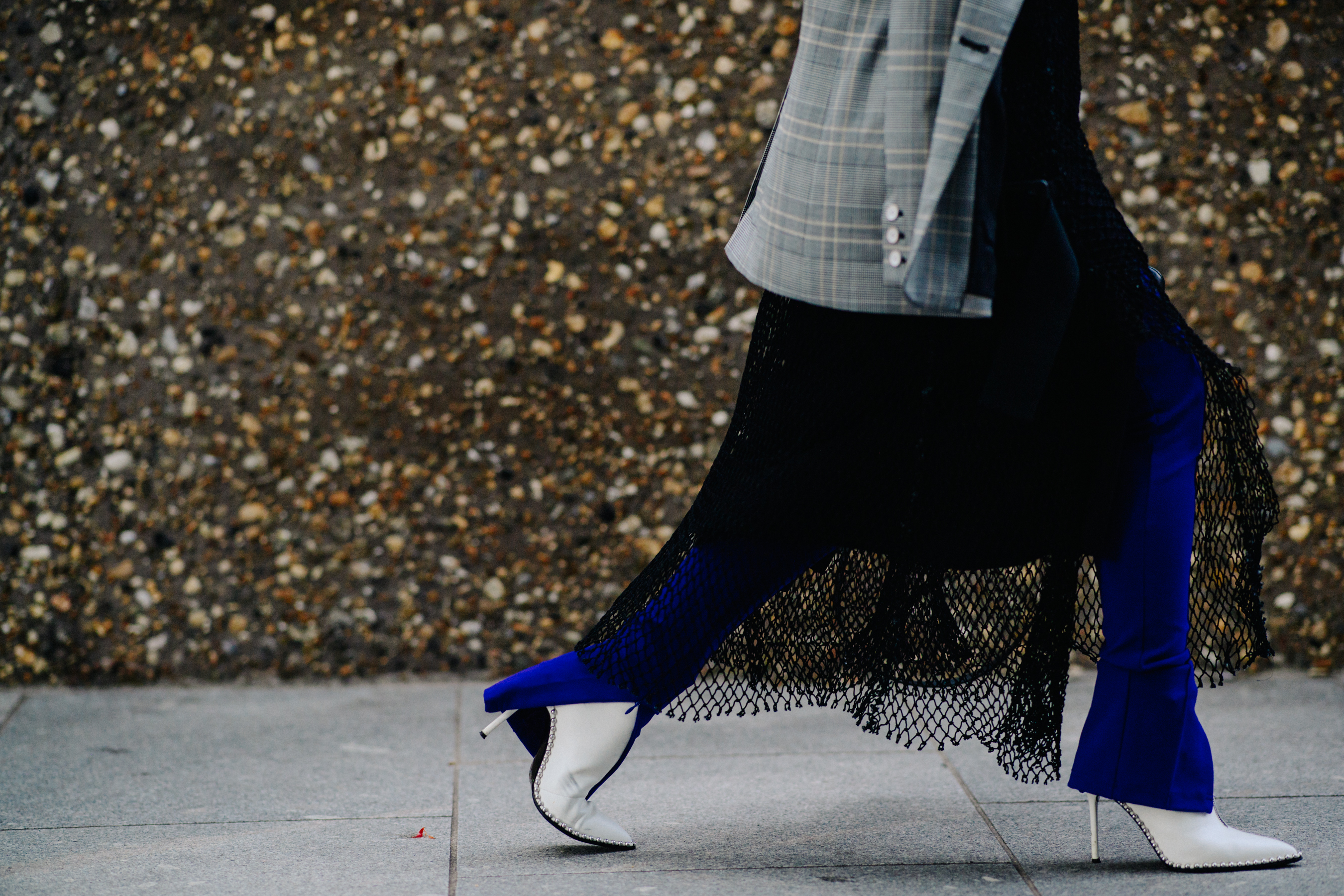 Woman wearing white boots and black skirt