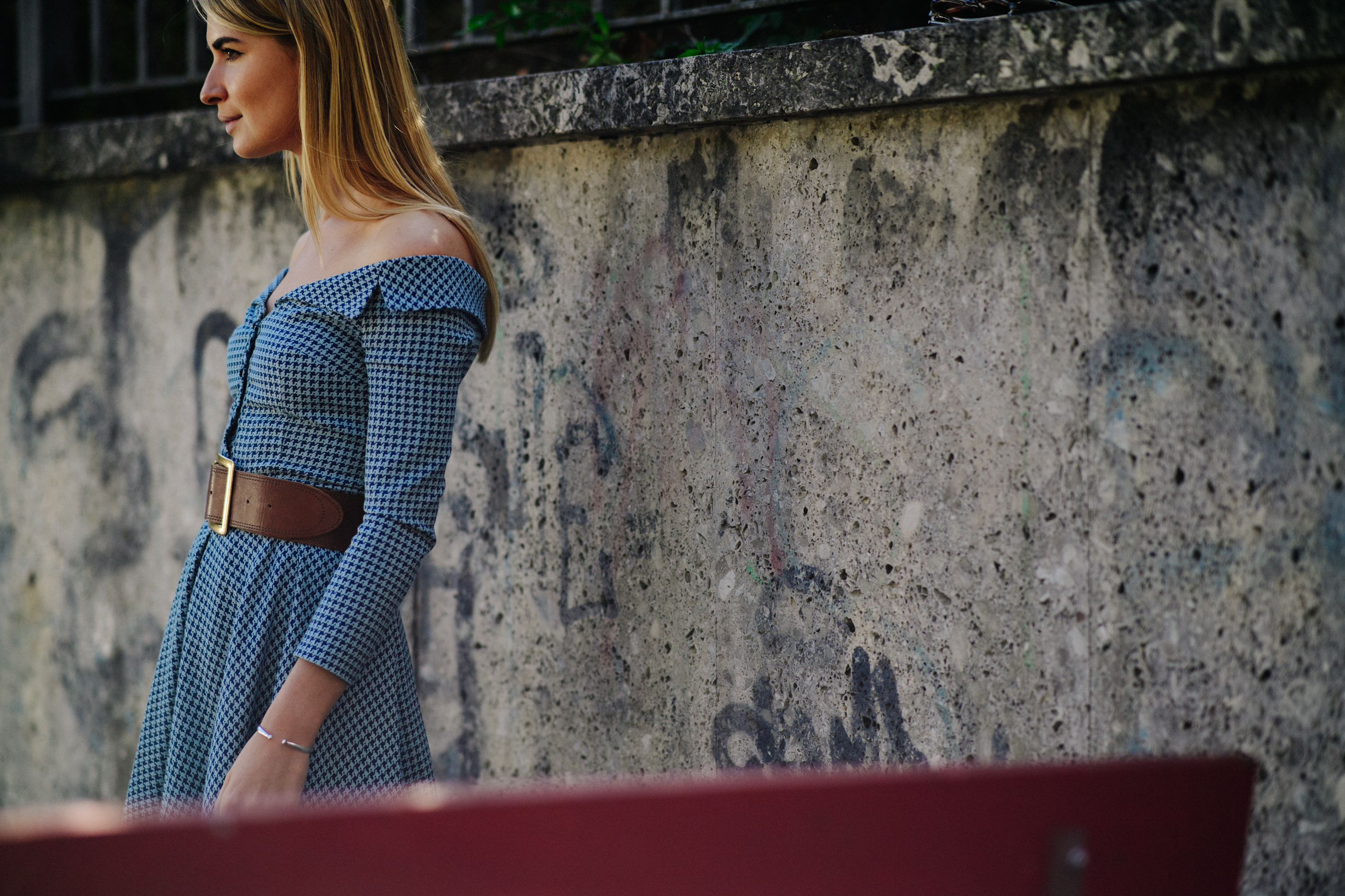 Blonde woman wearing patterned blue dress