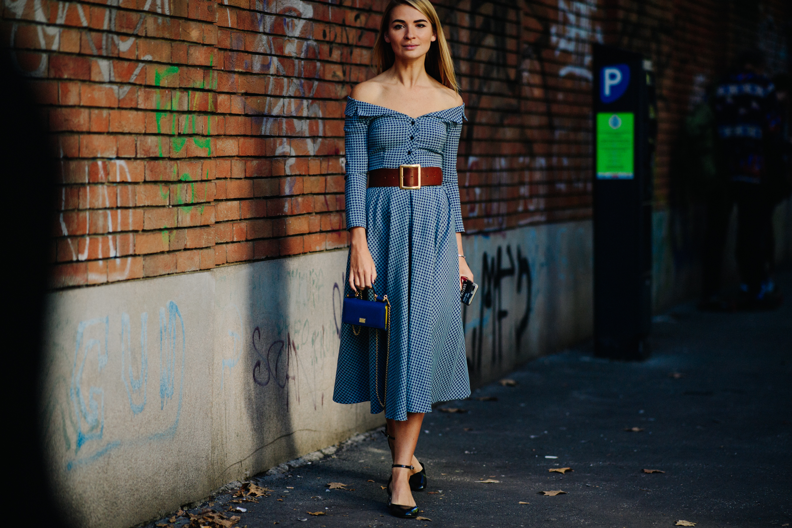 Woman wearing blue and holding blue bag