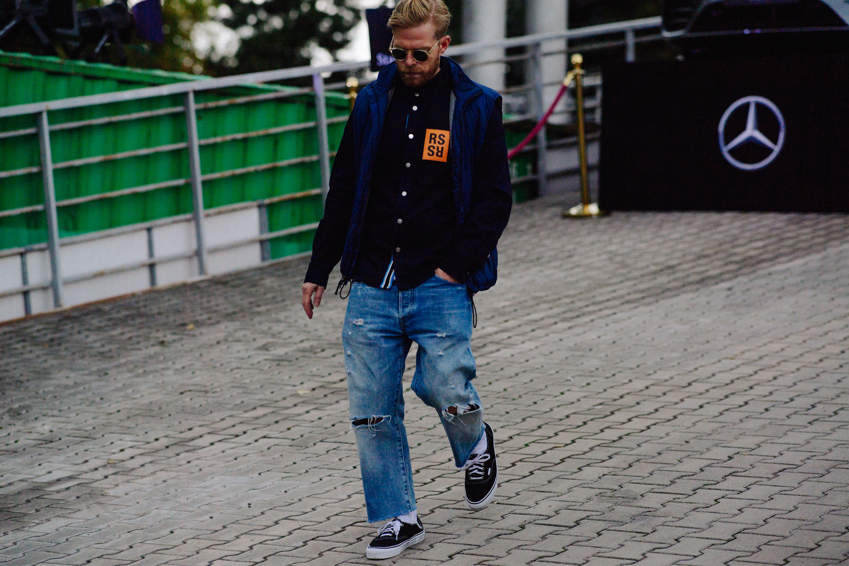 Store owner wearing Raf Simons shirt
