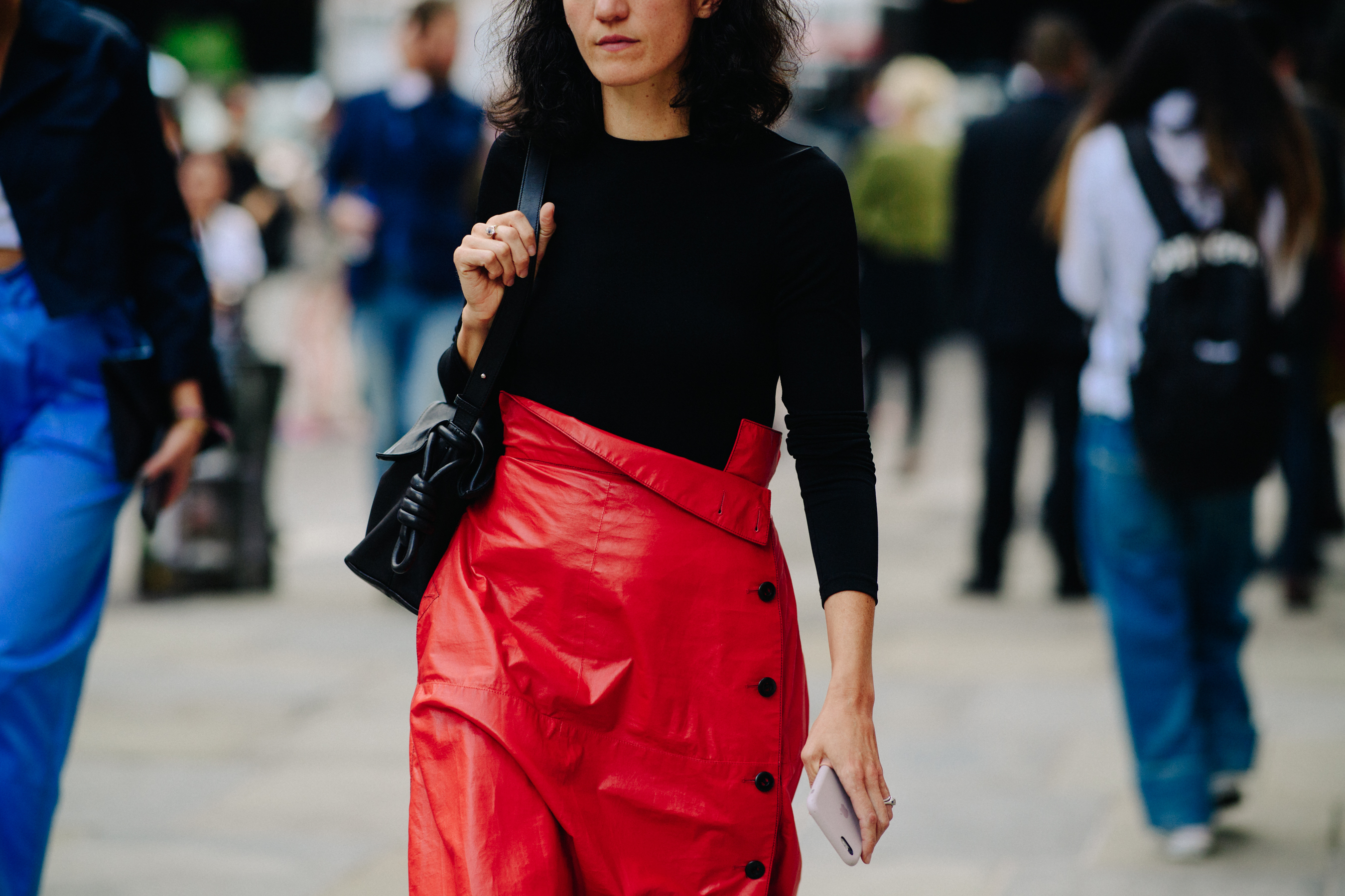 Woman wearing red skirt at Loewe bag