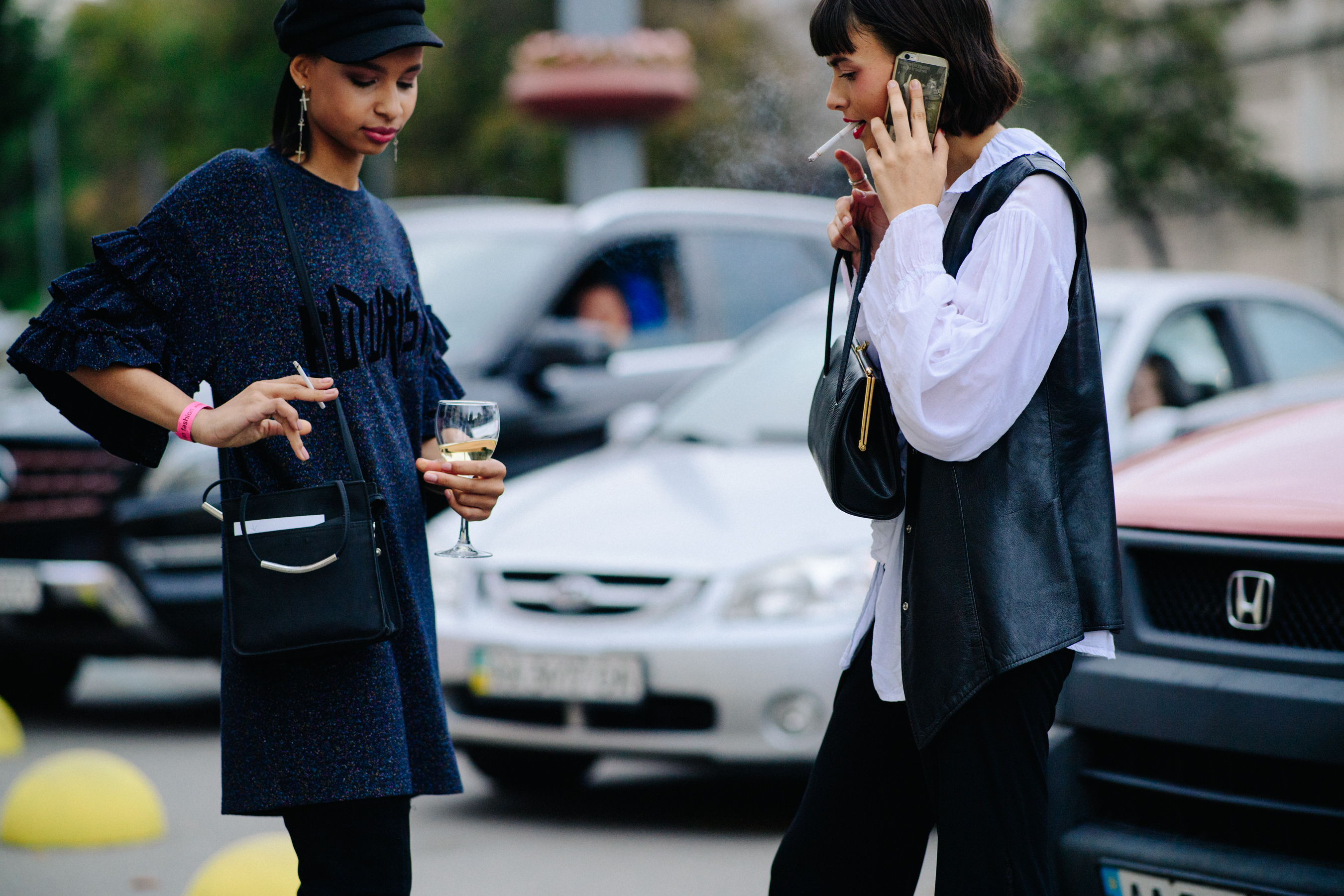 Two models smoking after a show