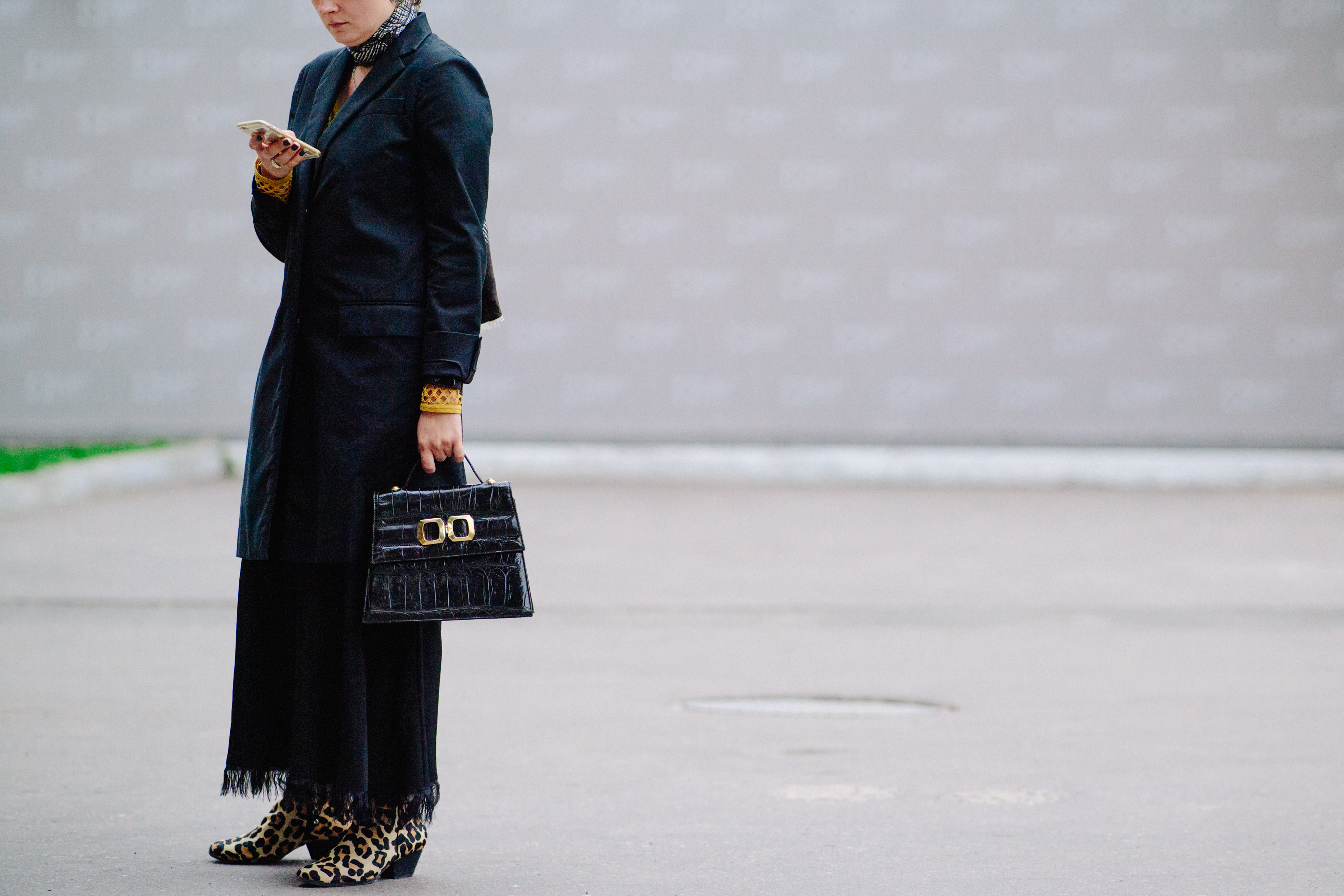 Woman wearing coat and animal print boots