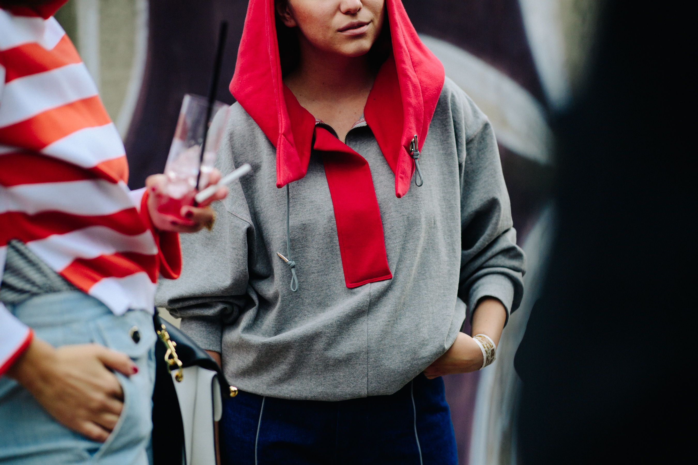 Woman wearing top with red hood