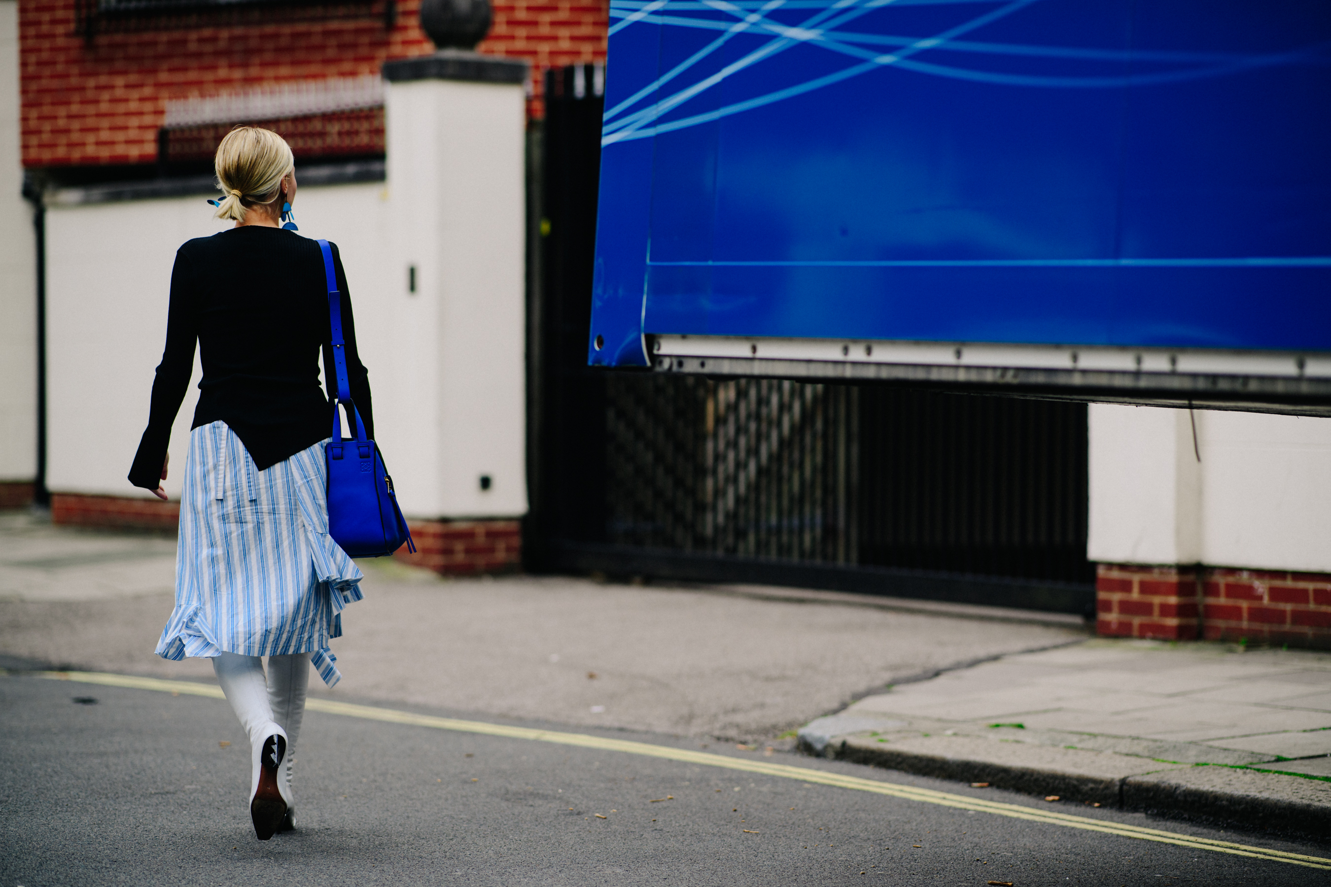 Woman wearing J.W.Anderson blue bag
