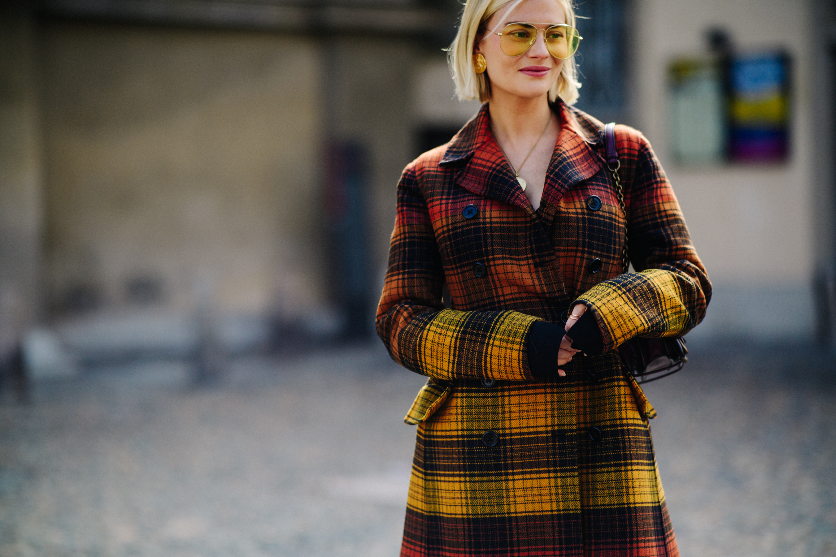 Blonde woman wearing red and yellow gradient coat