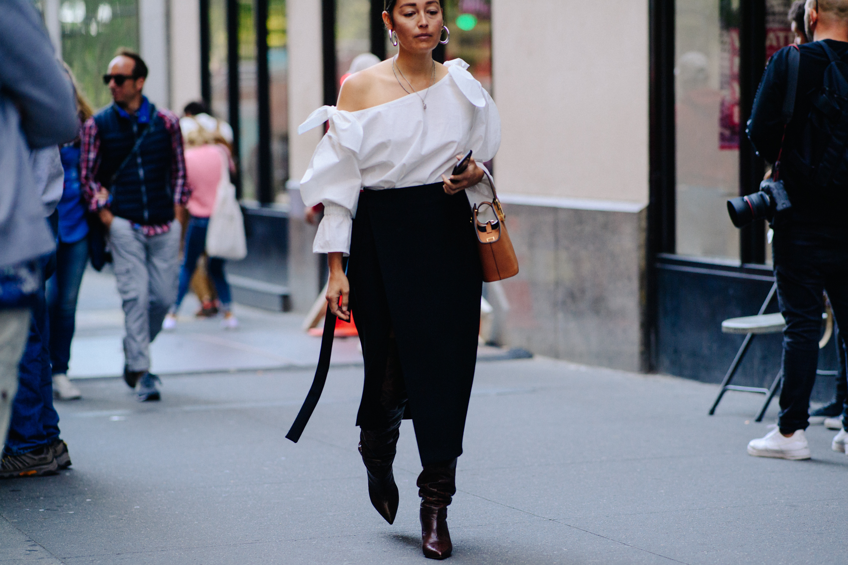 Editor wearing white top and black skirt
