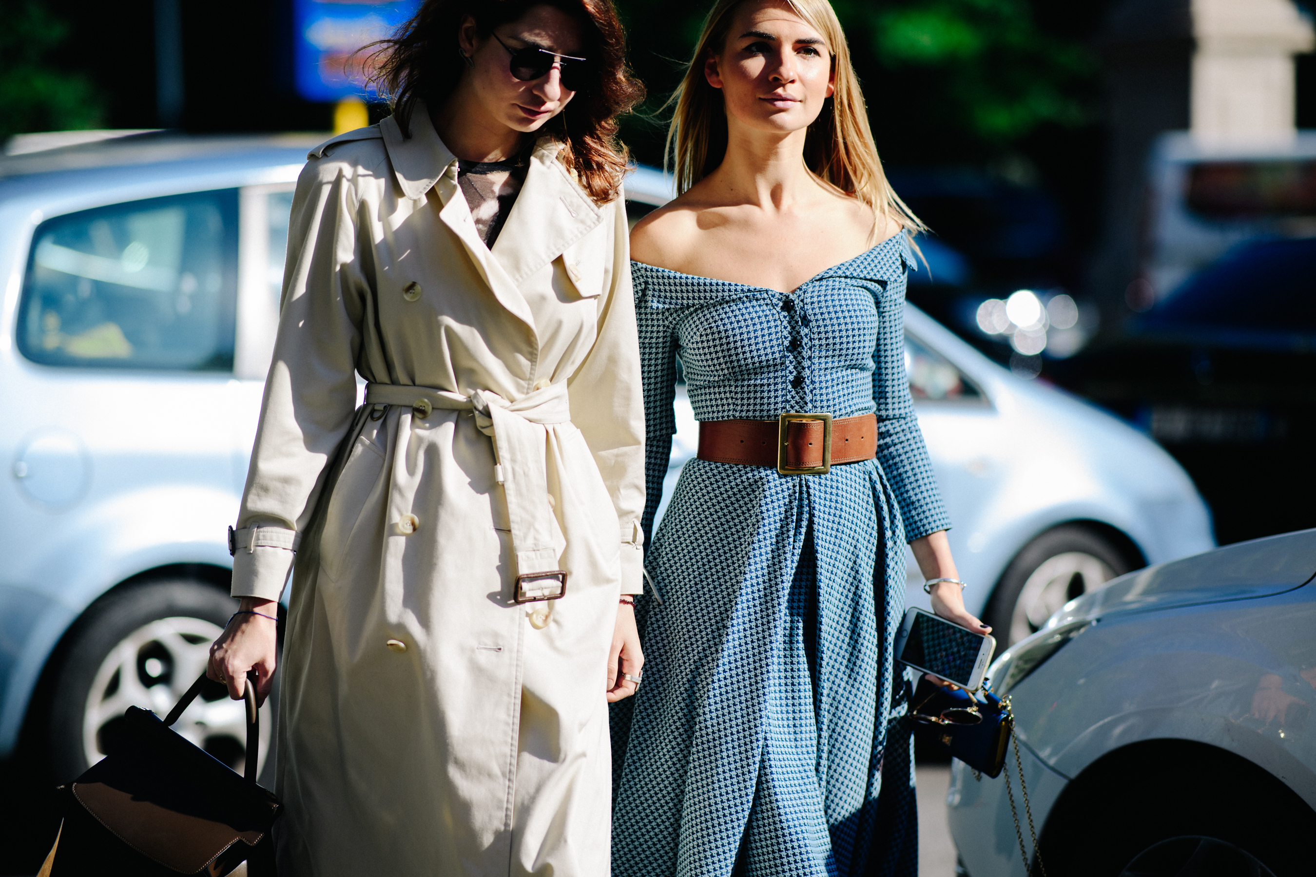 Two women wearing belted outfits
