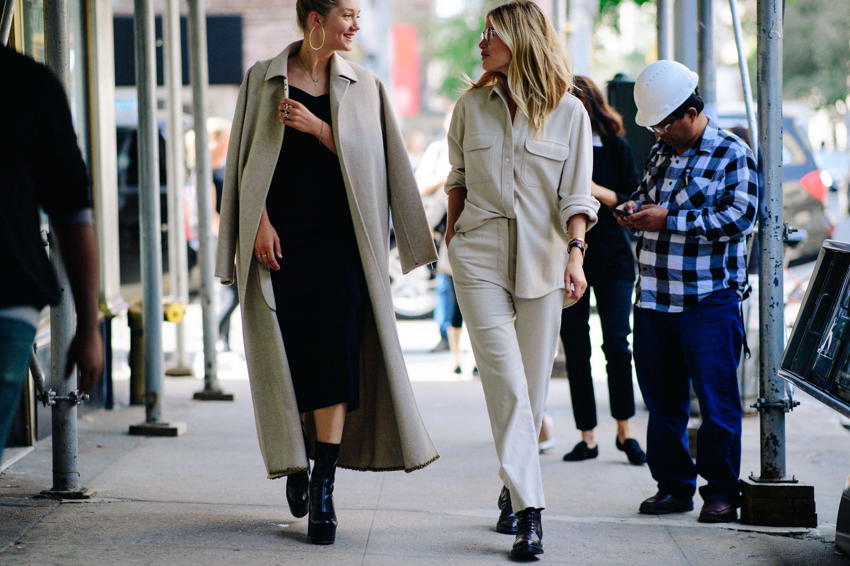 Two women wearing beige outfits