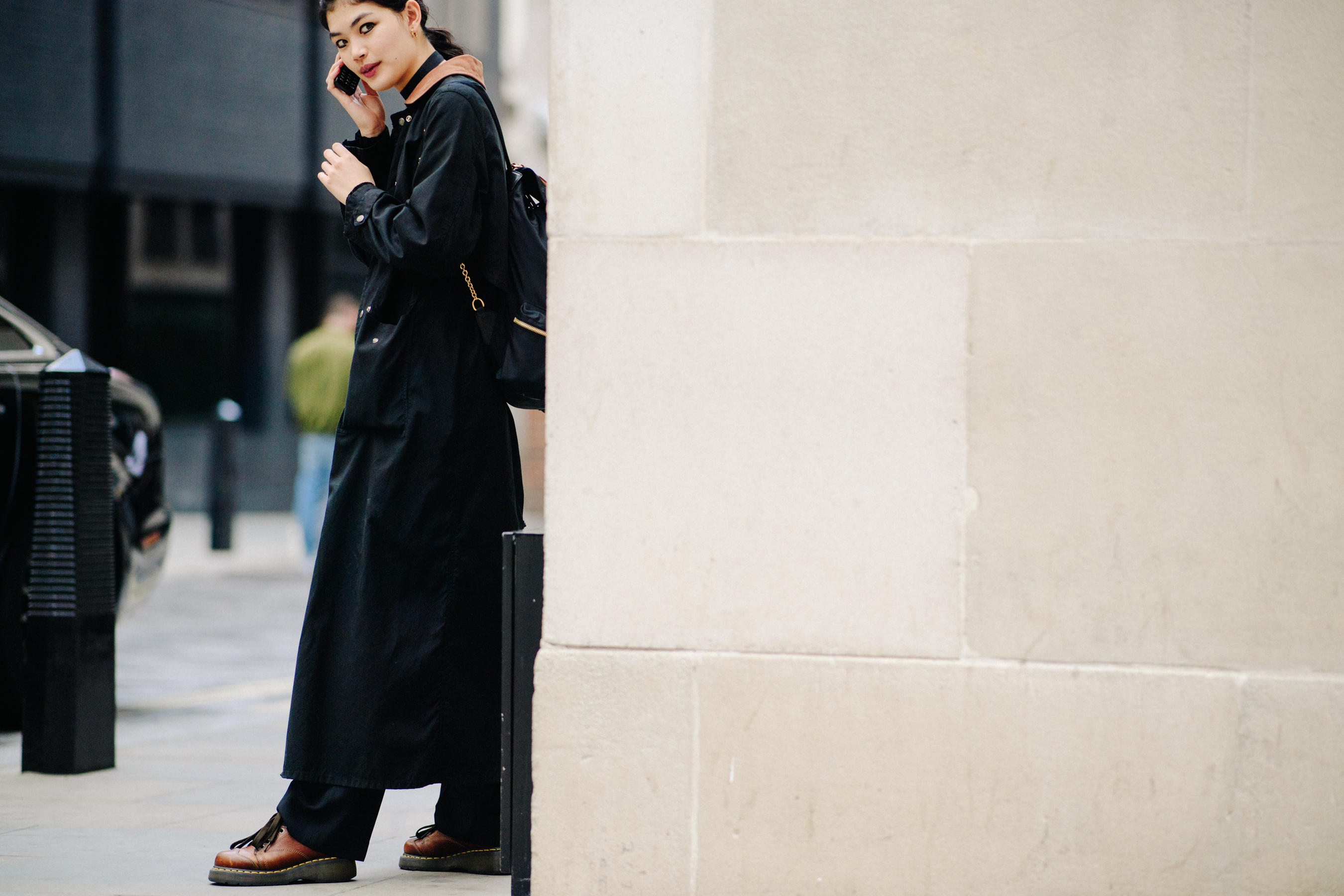 Filipina model wearing long black coat