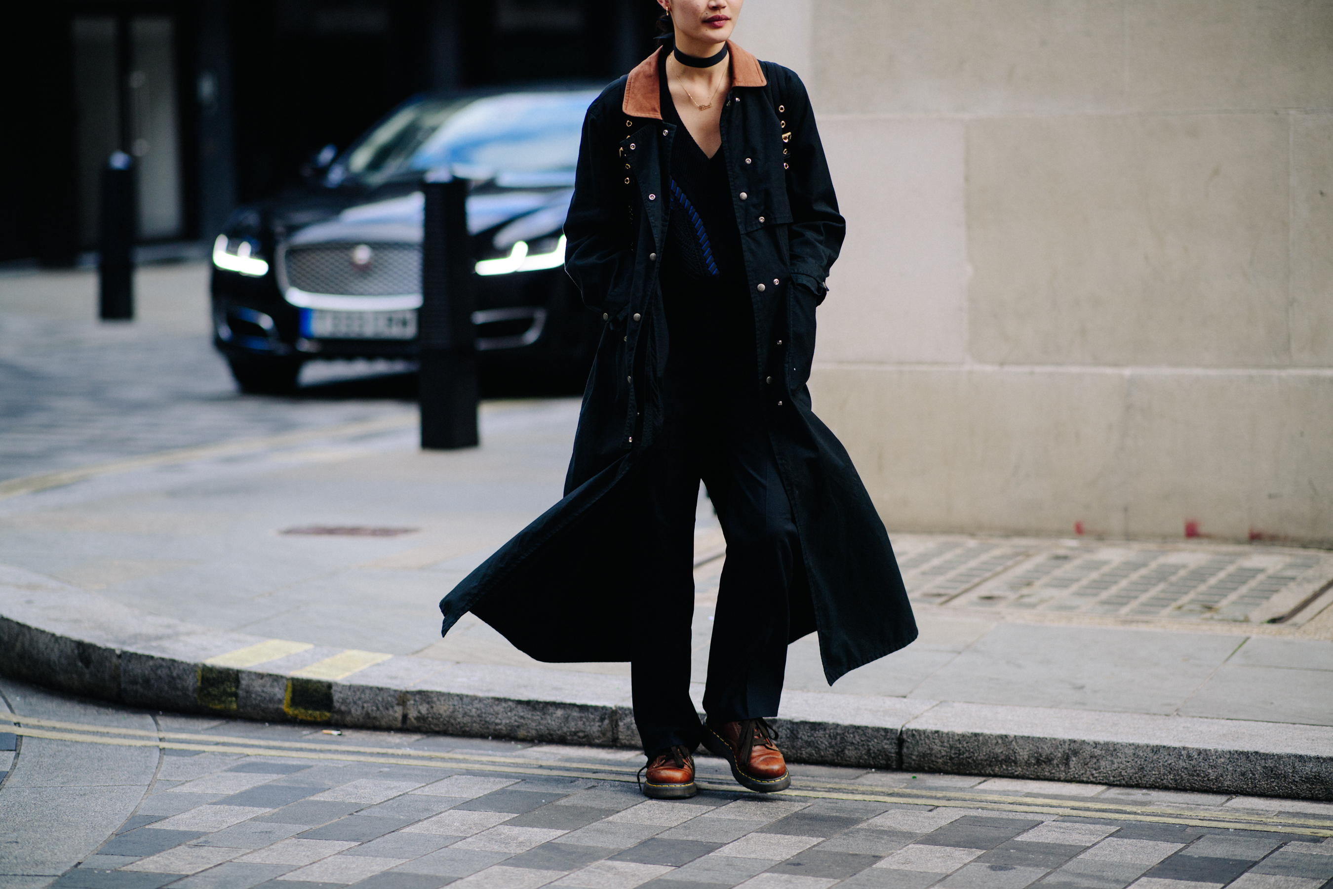 Filipina model wearing long black coat