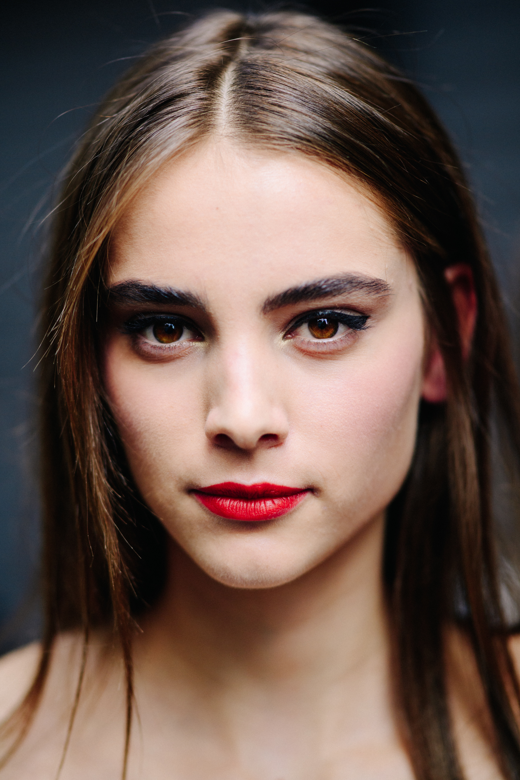 Portrait of a model with red lips after the show