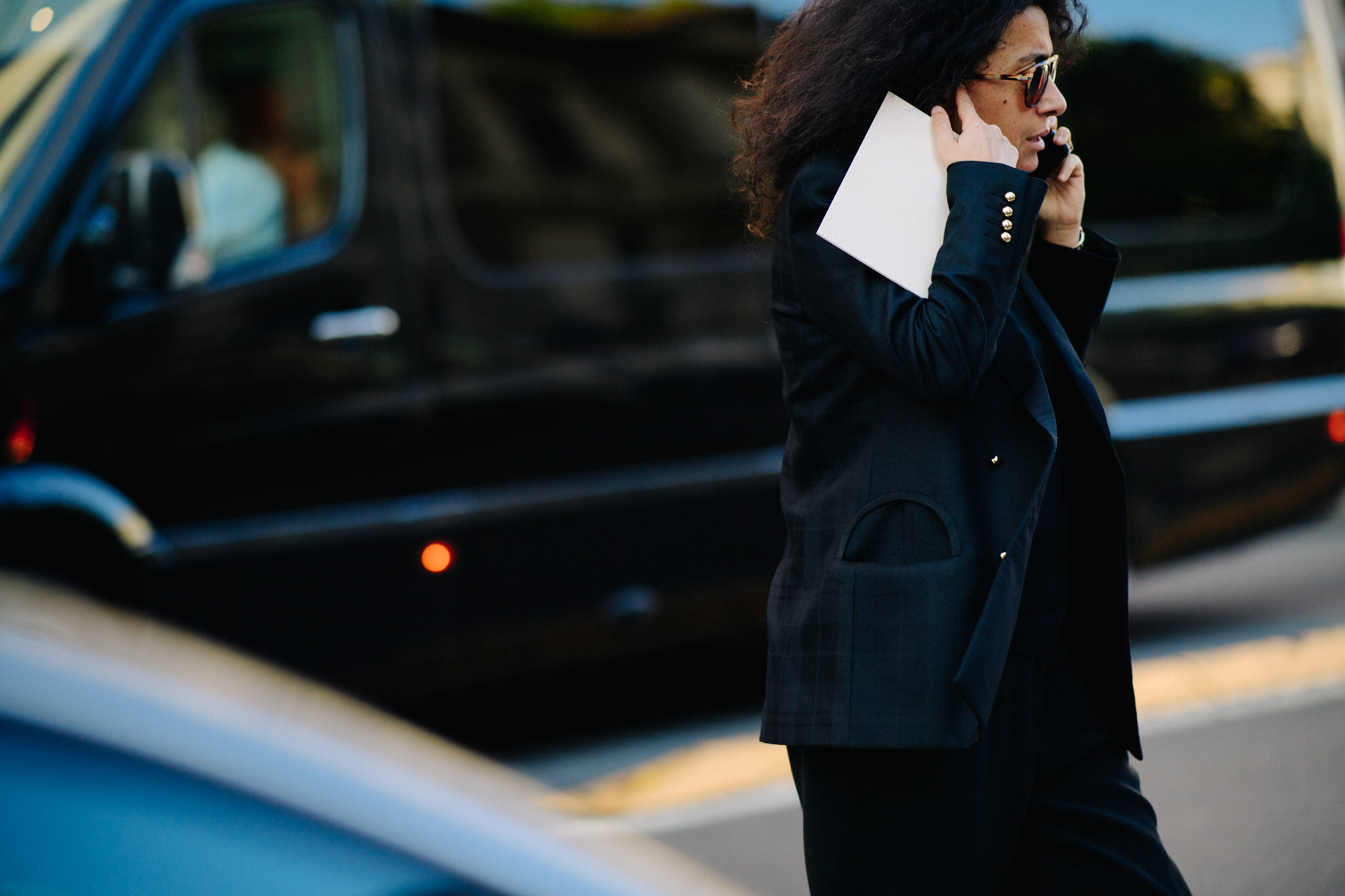 Woman on phone in dark outfit