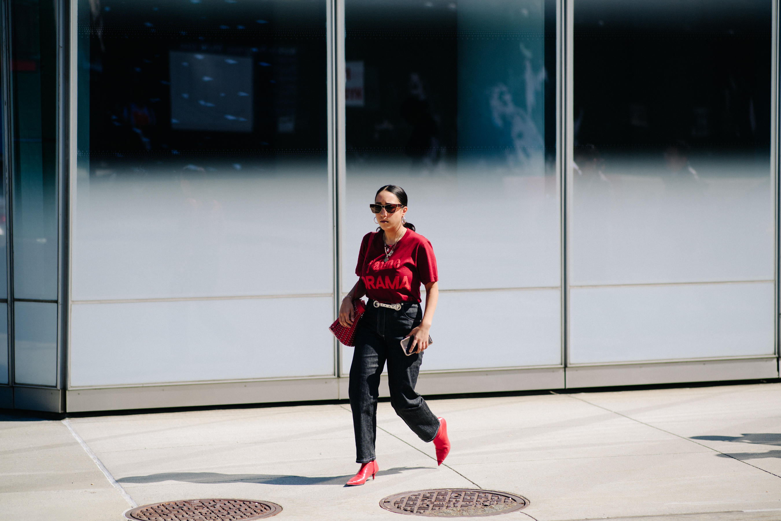 Woman wearing black jeans and red shoes