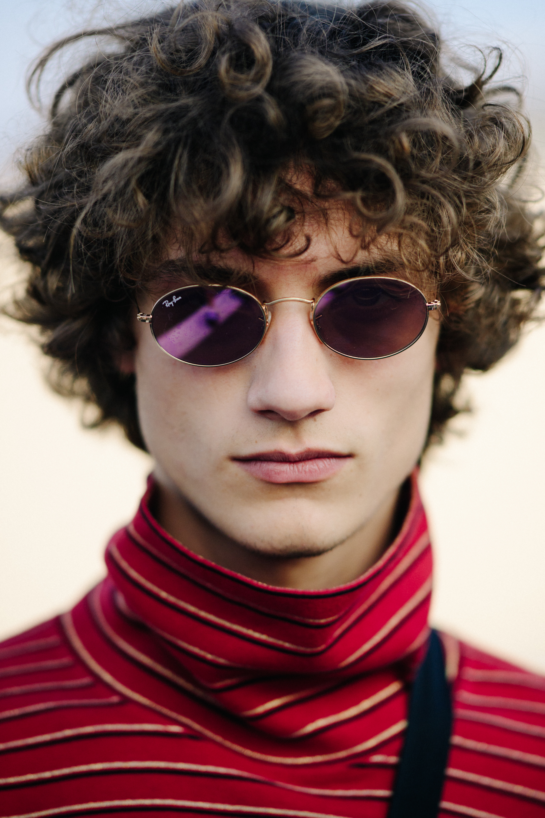 Portrait of male model wearing purple lens glasses