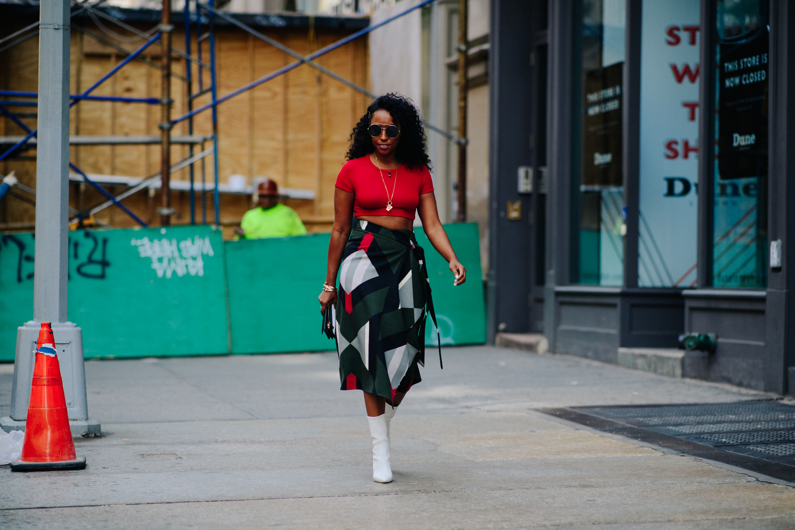Stylist wearing red top and skirt