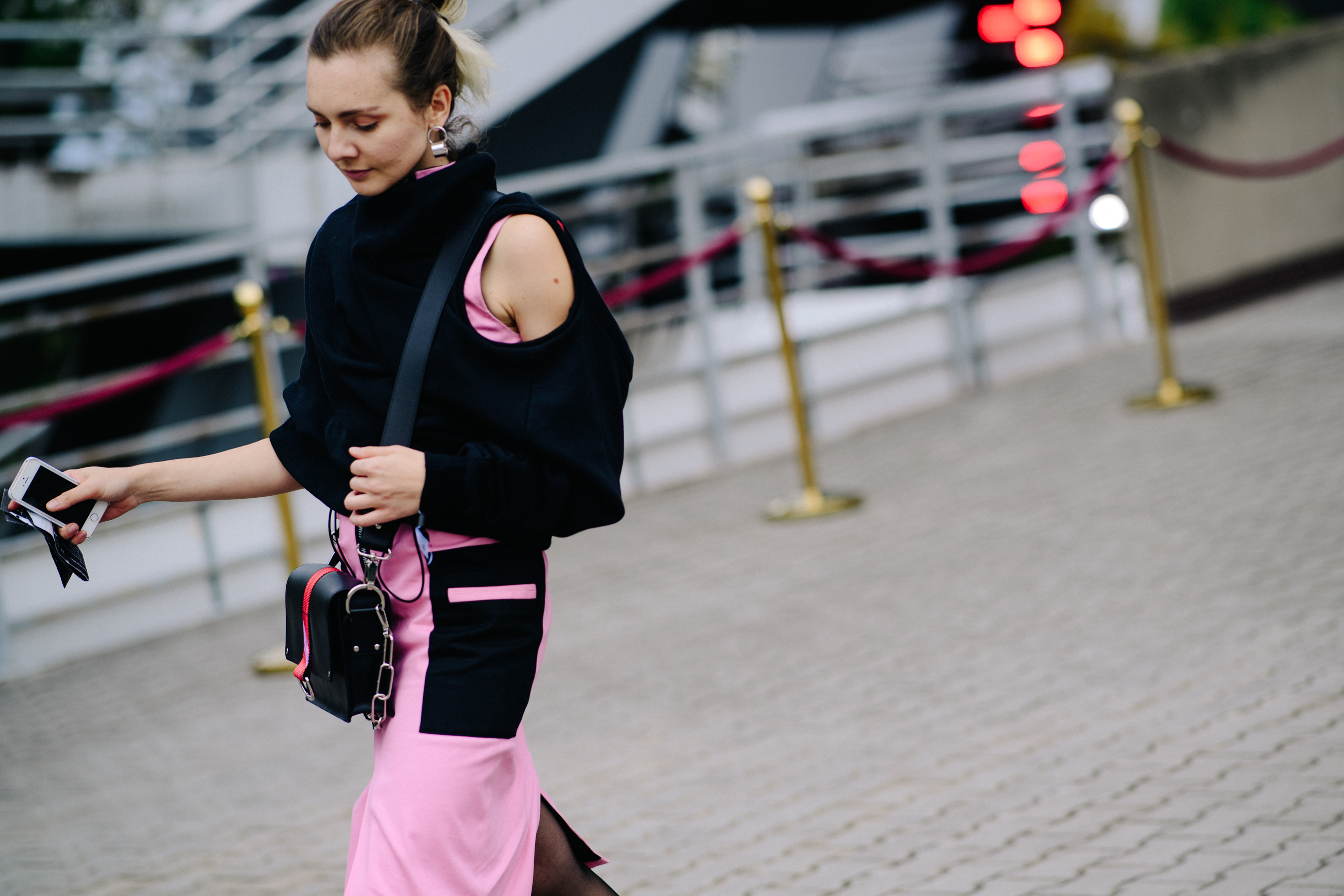 Girl wearing Prada bag and pink skirt