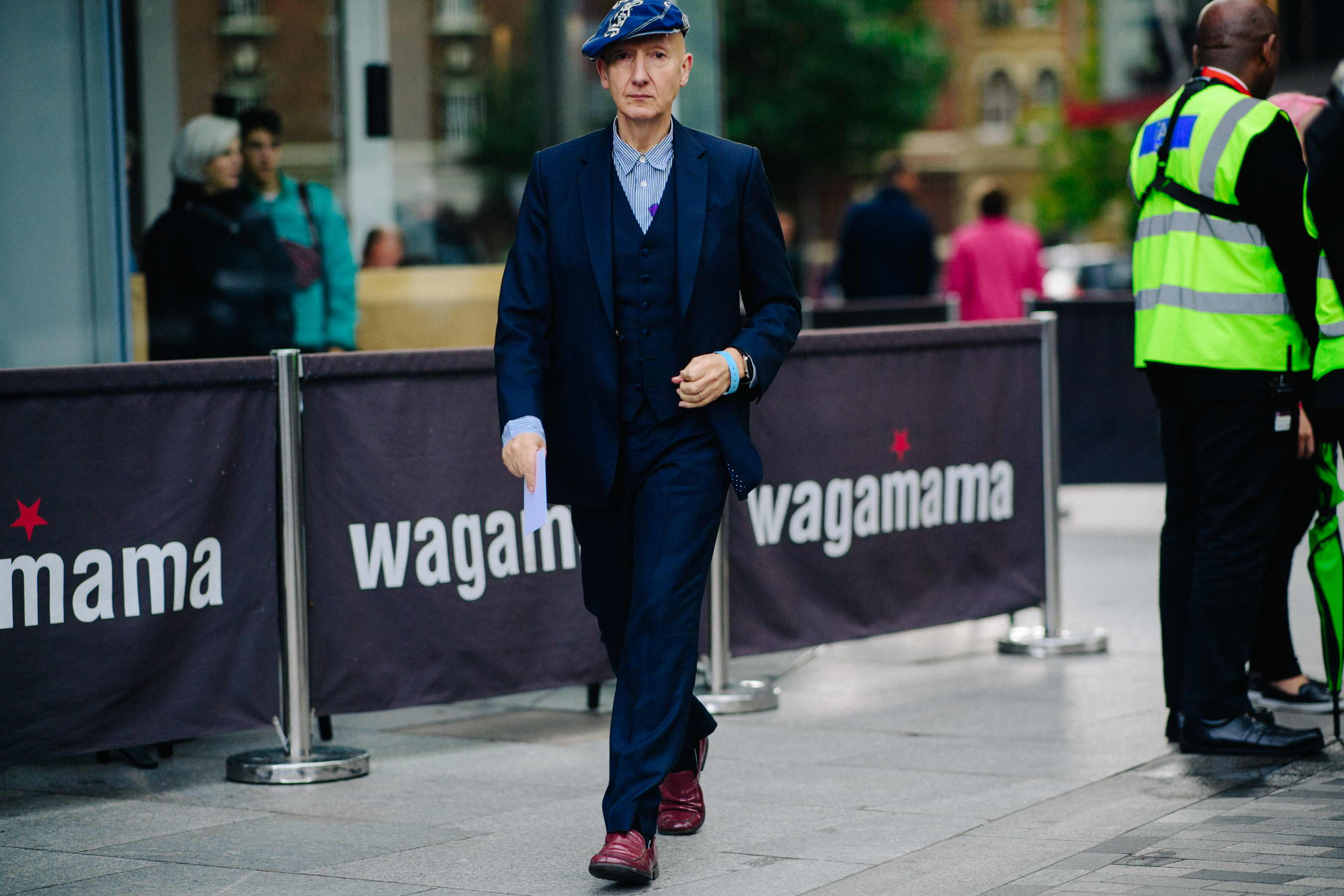 Milliner wearing suit and a hat