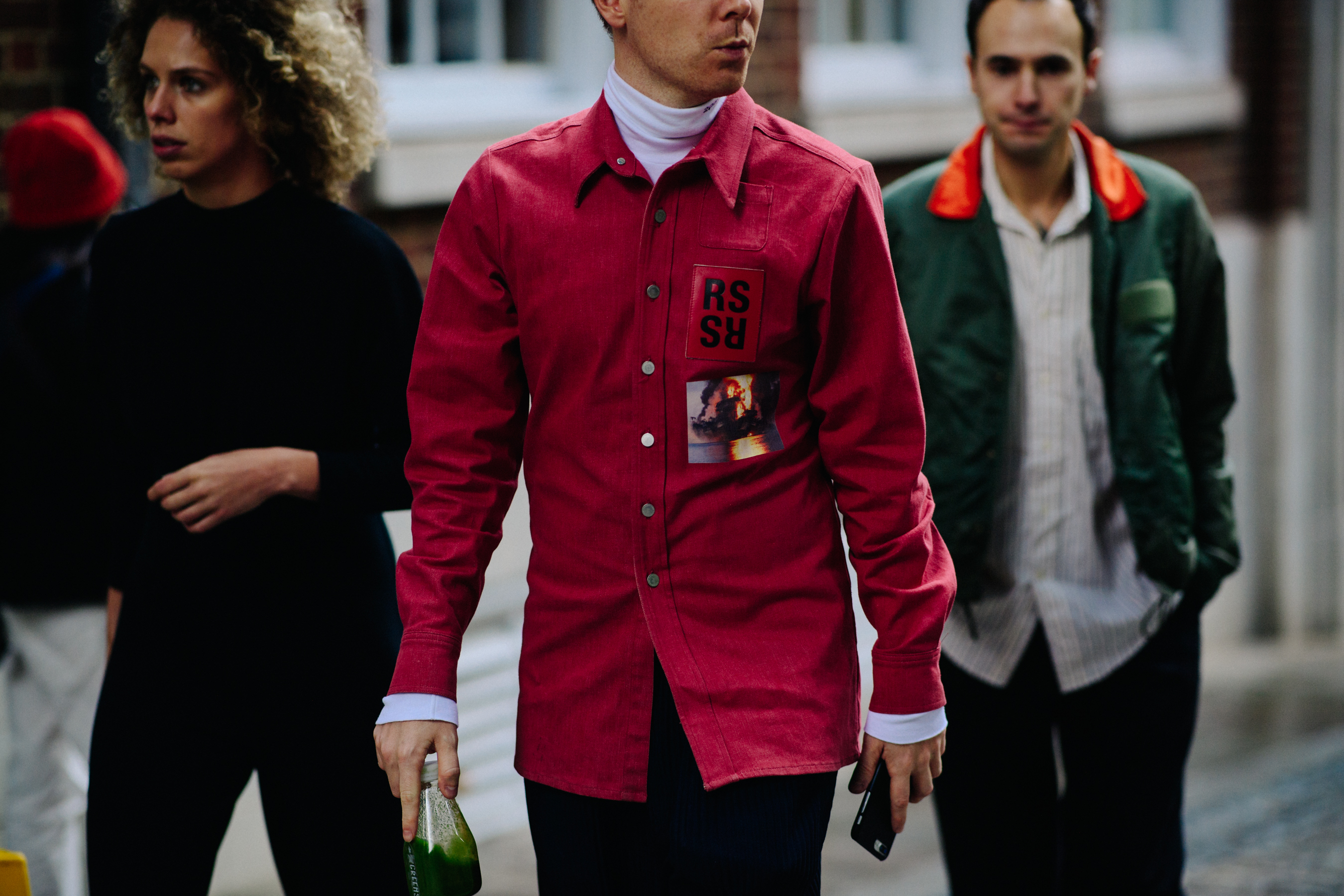 Man wearing red Raf Simons shirt