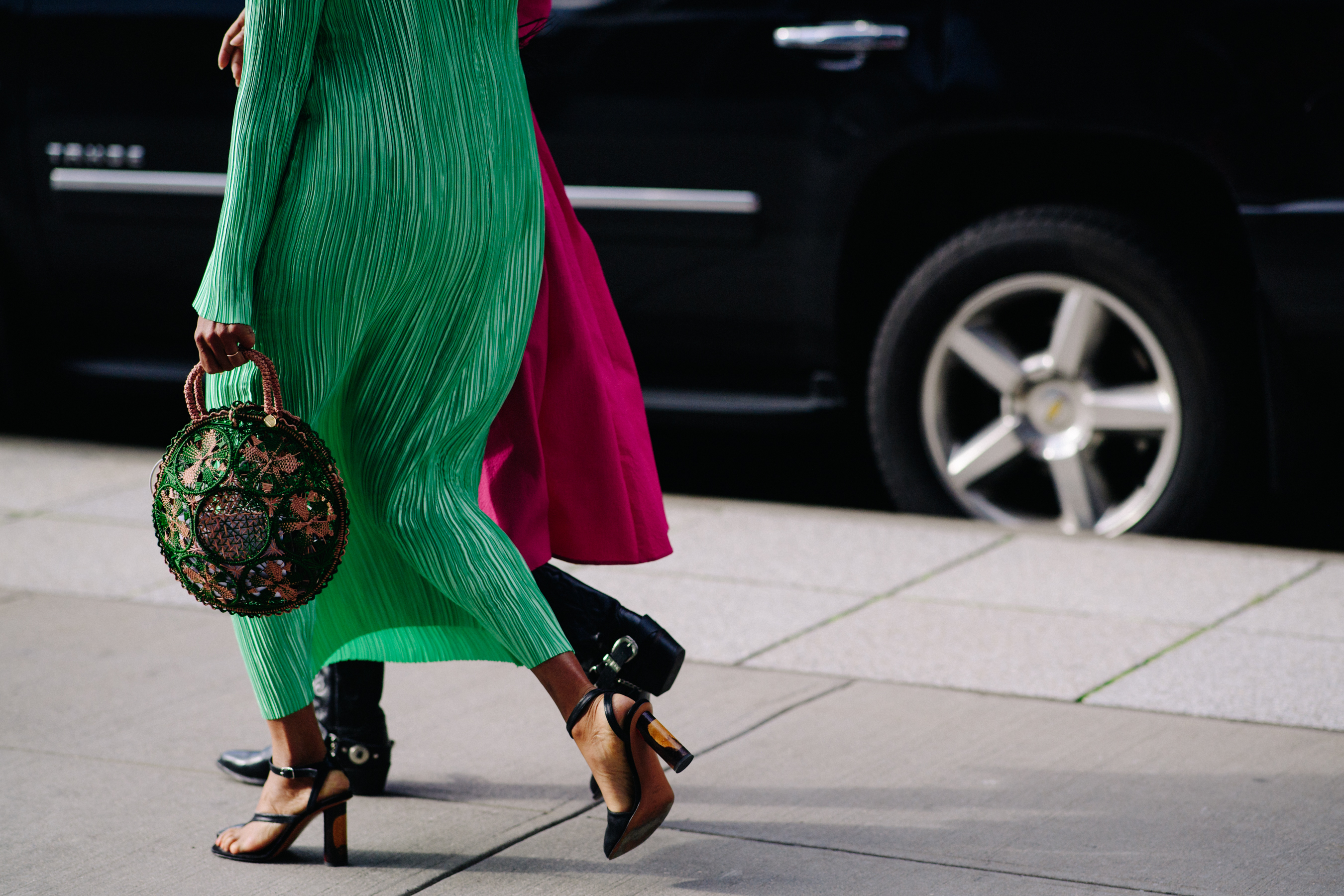 Two women wearing pink and green