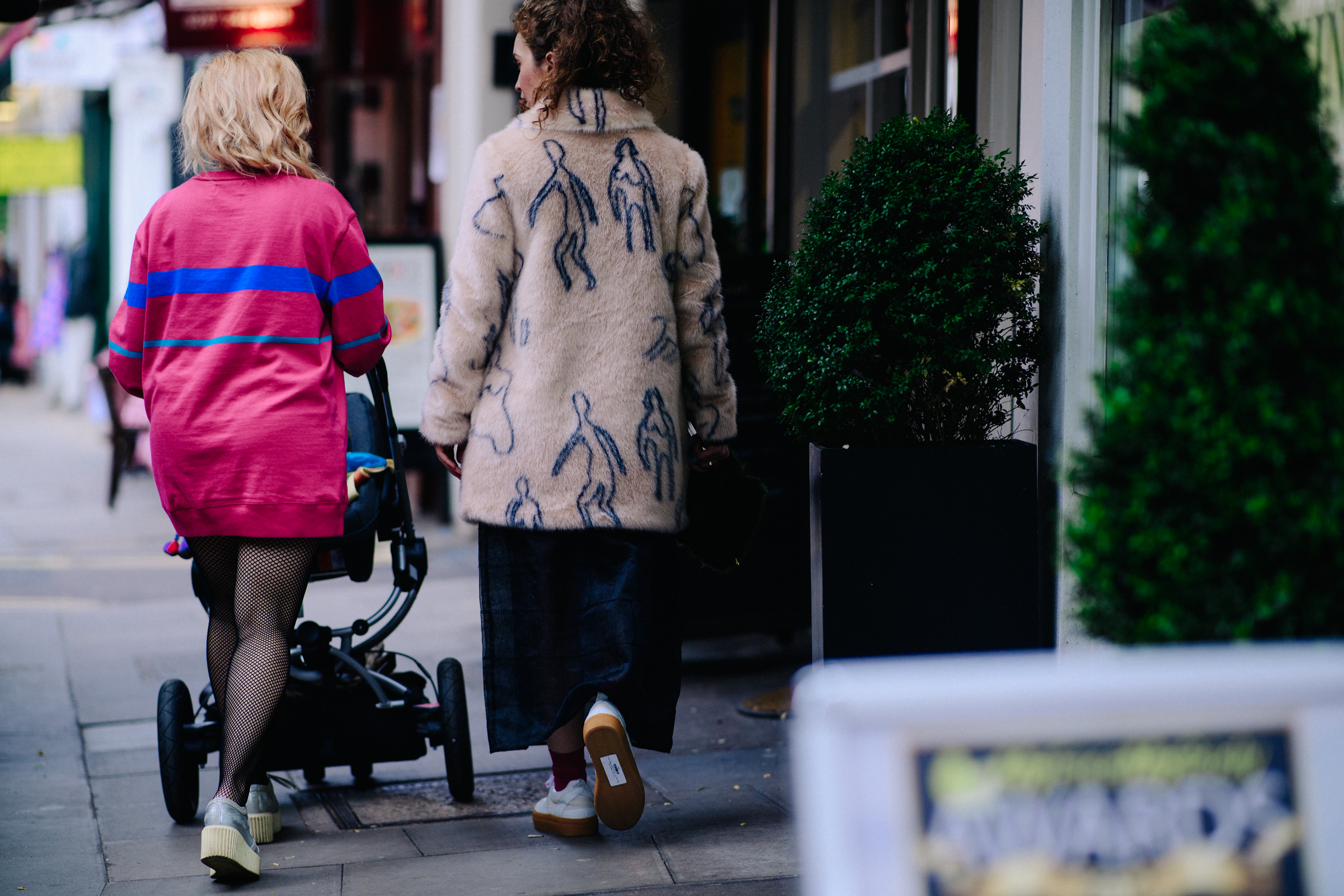 Two women wearing pink and faux fur