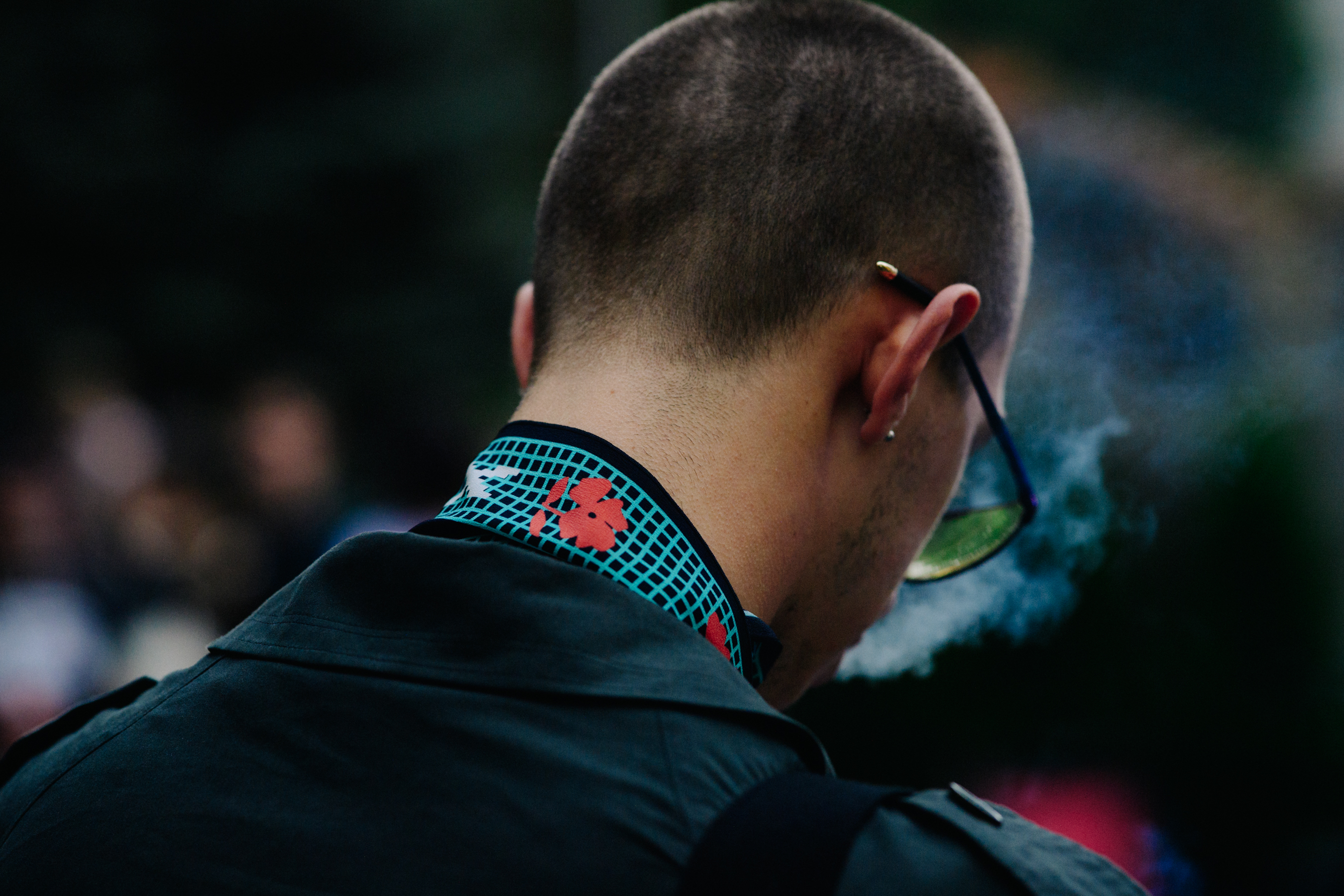 Man wearing yellow glasses and smoking