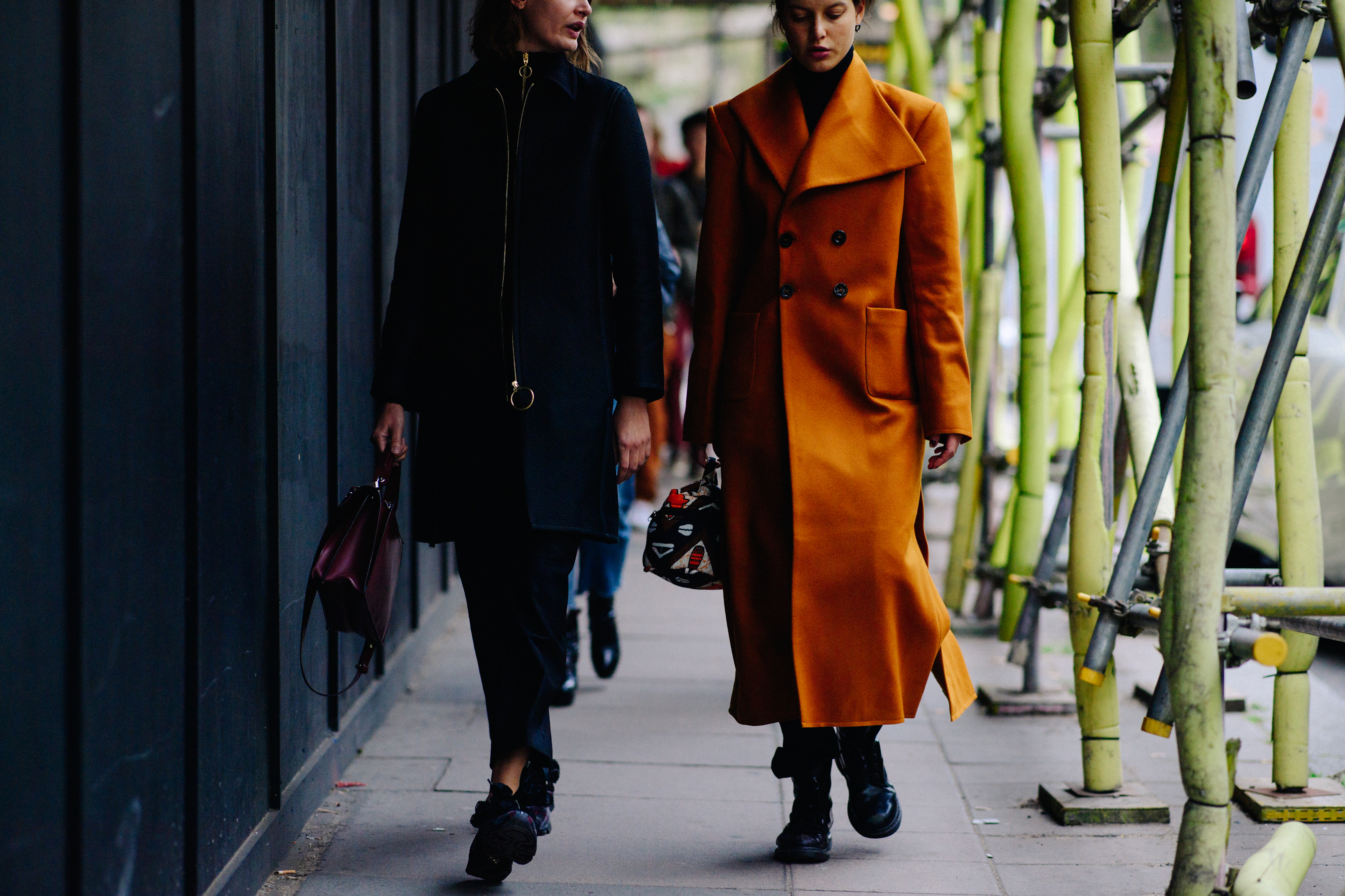 Two women wearing coats