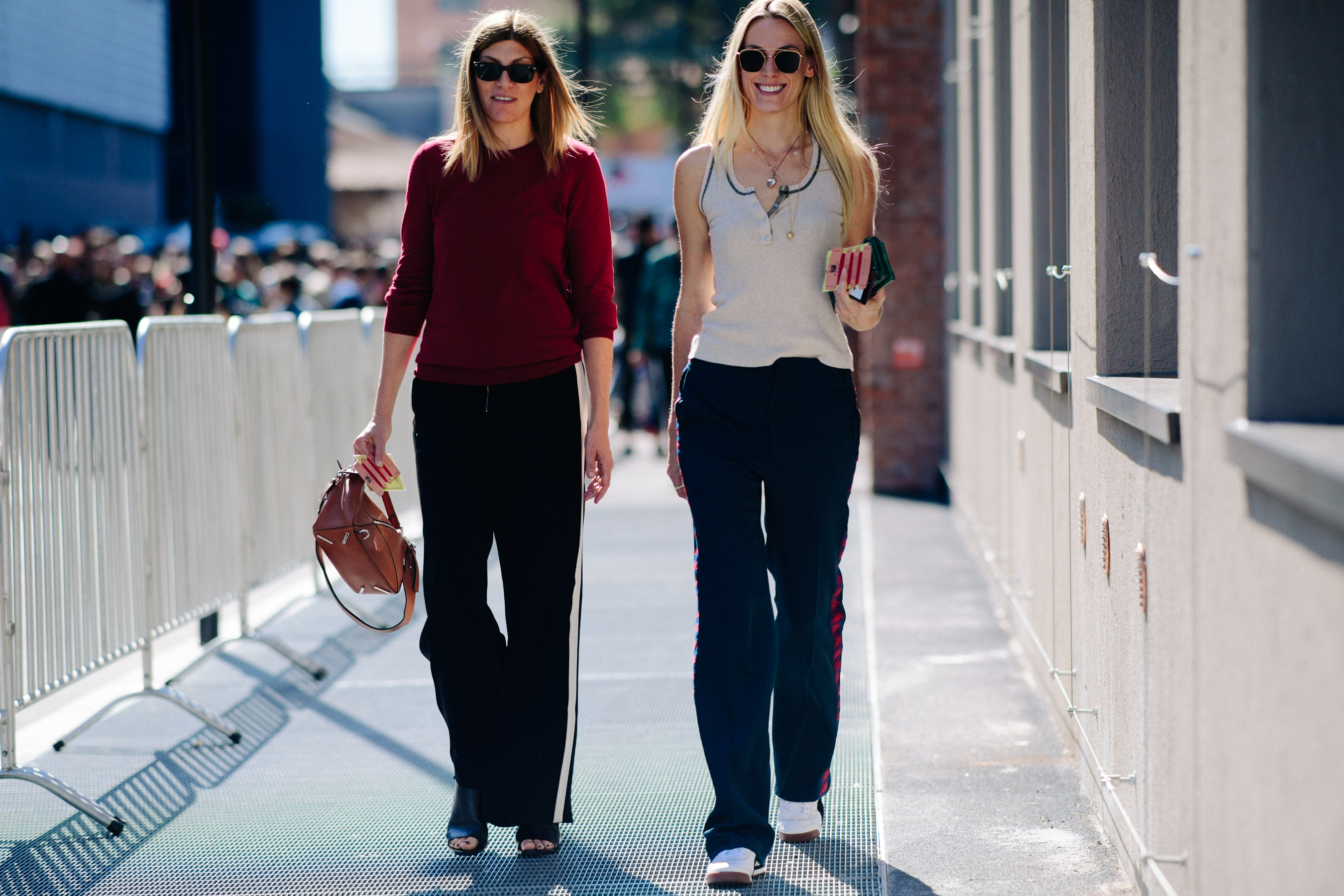 Two blonde women wearing casual pants