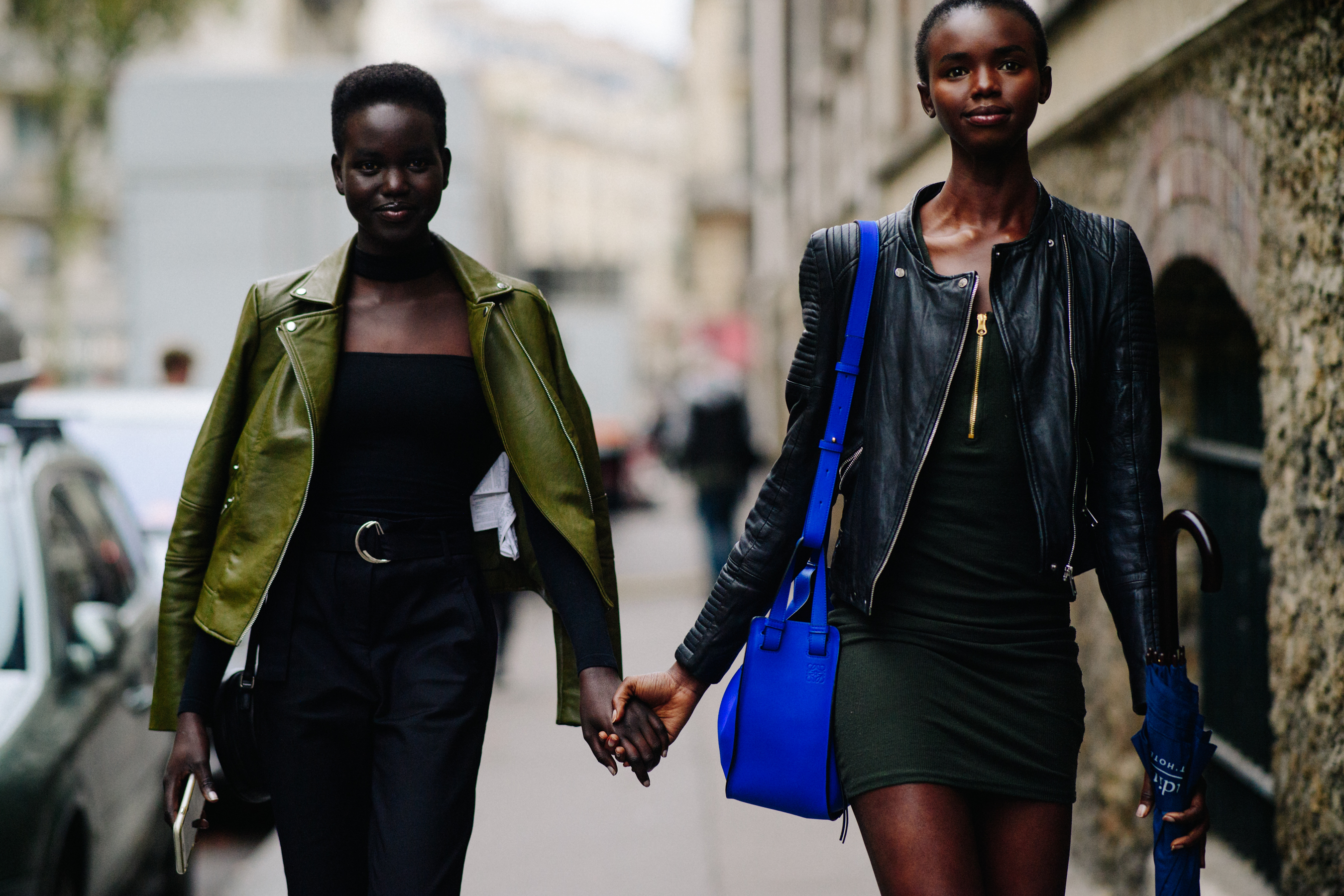 Two models holding hands after a show