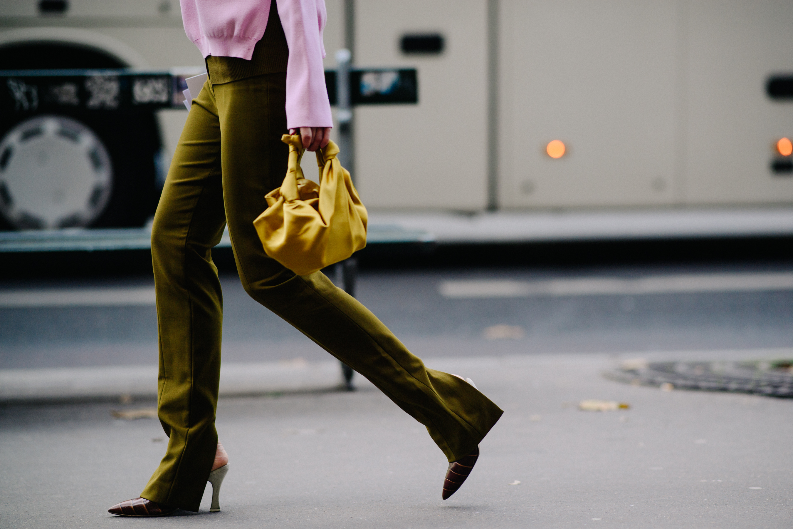 Woman wearing mustard colour bag