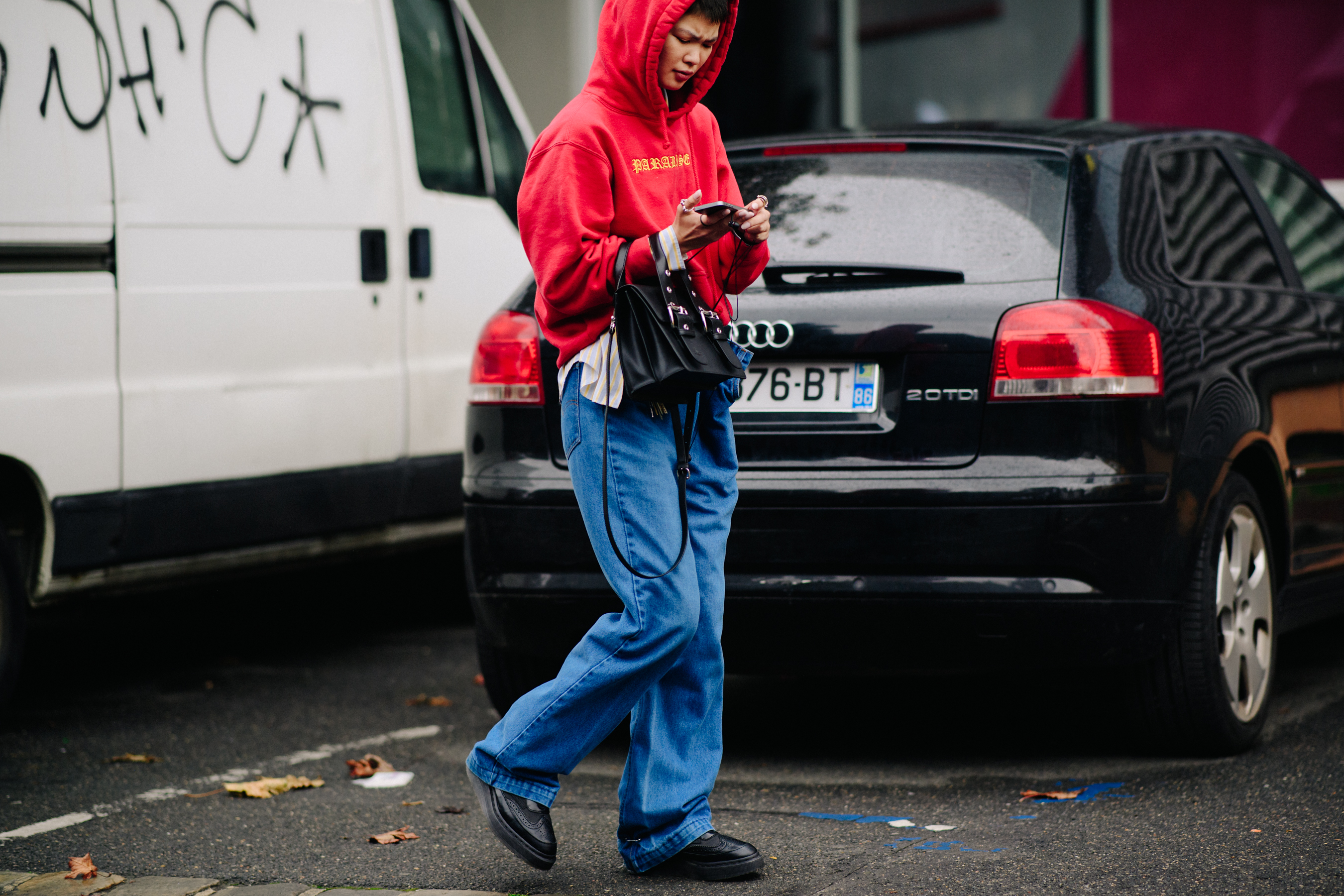 Model wearing red hoodie after a show