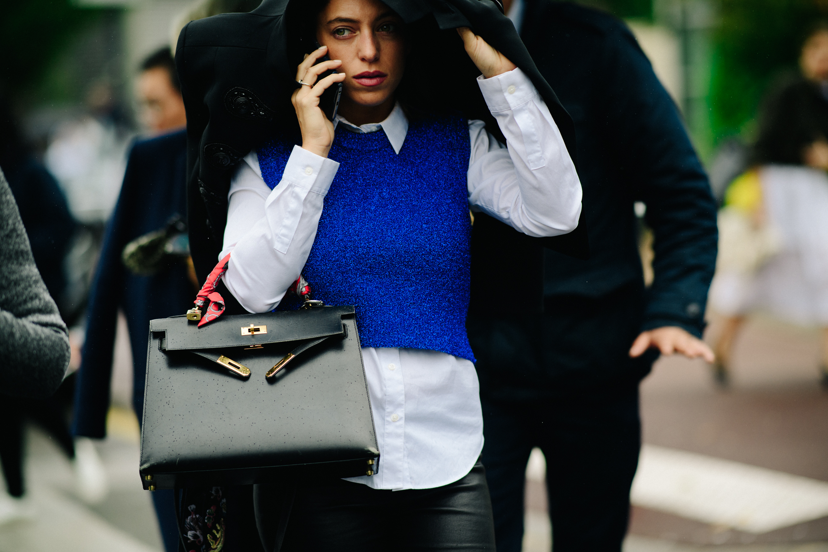 Woman wearing blue top over shirt