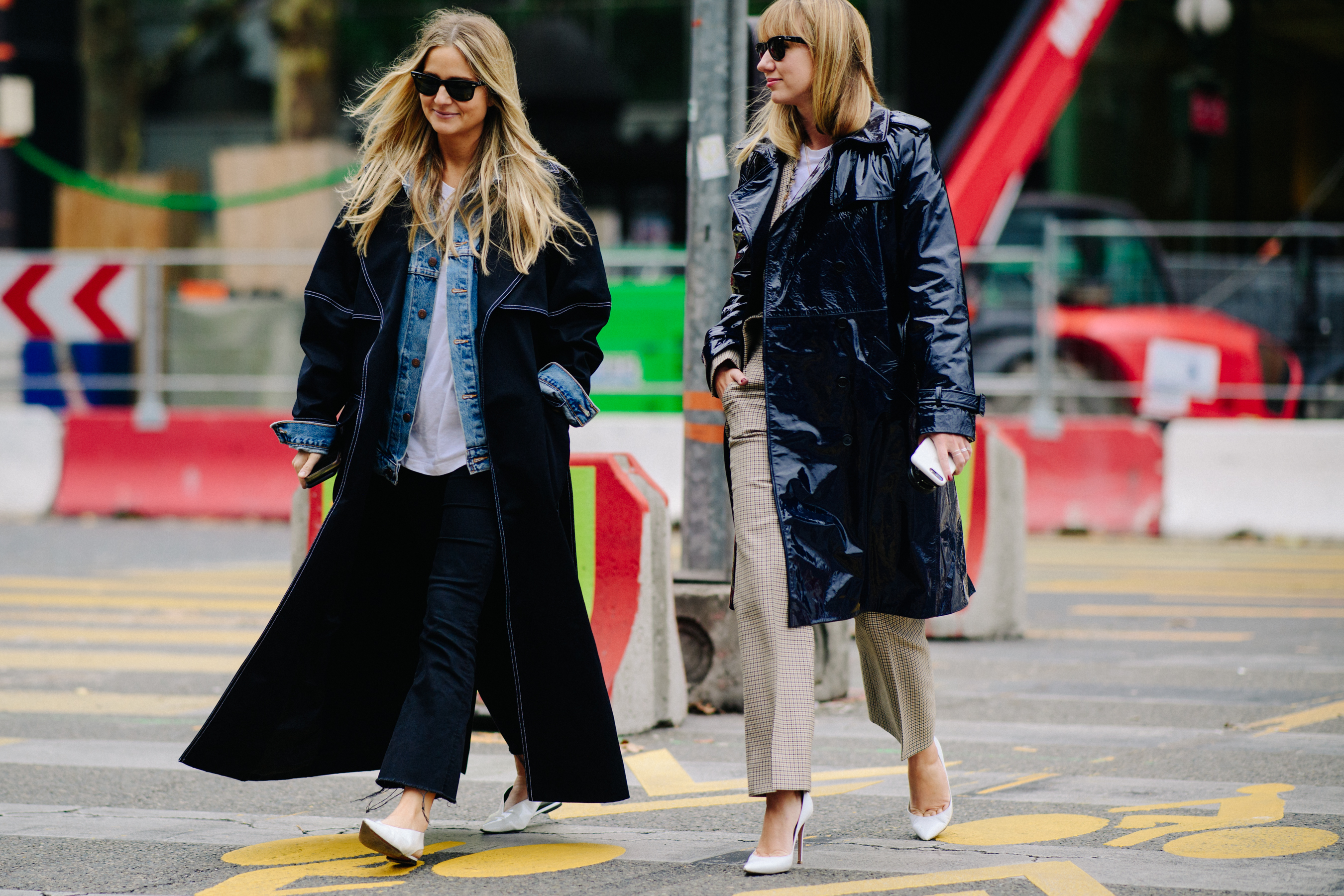 Two women wearing black coats