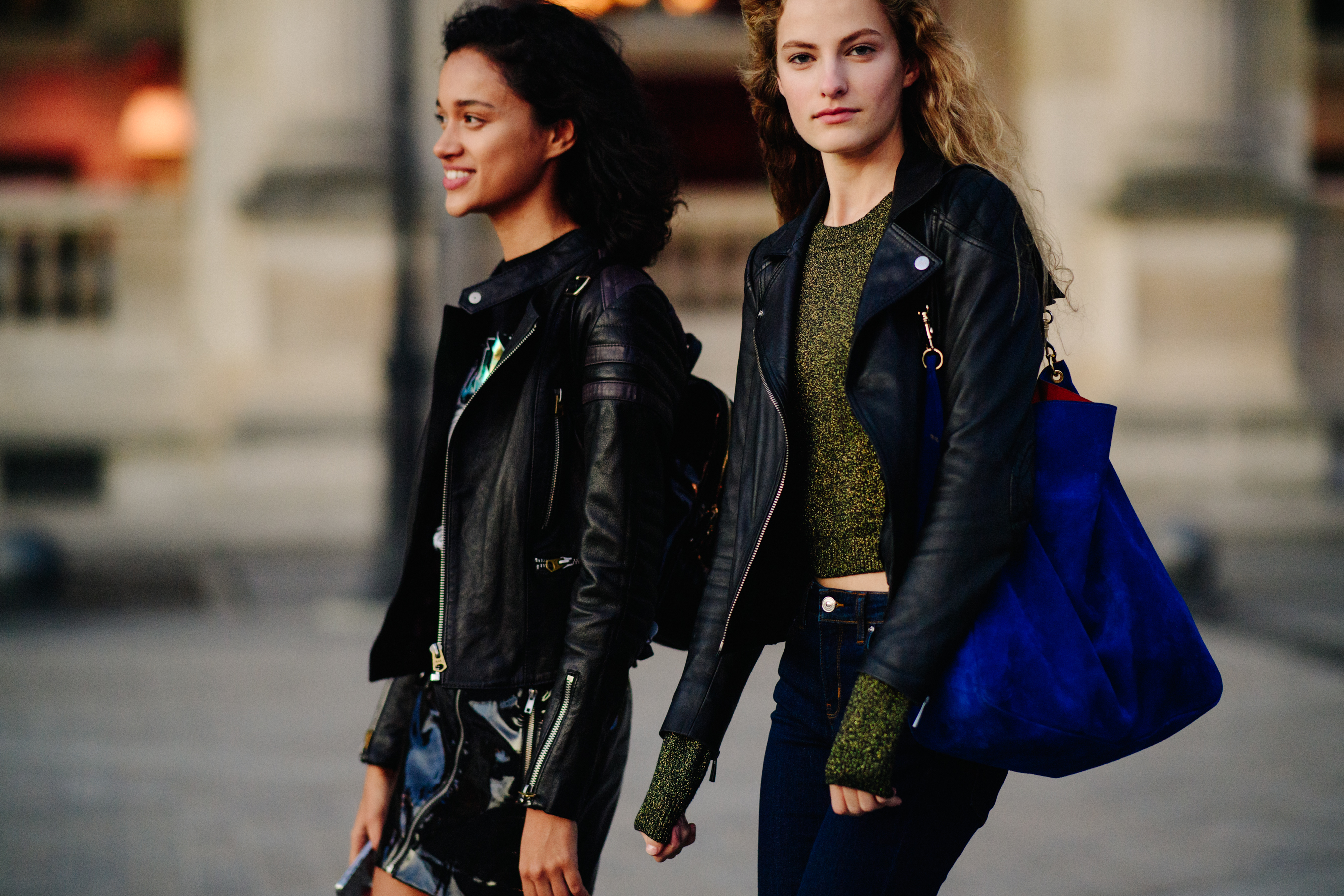 Two models wearing black leather jackets