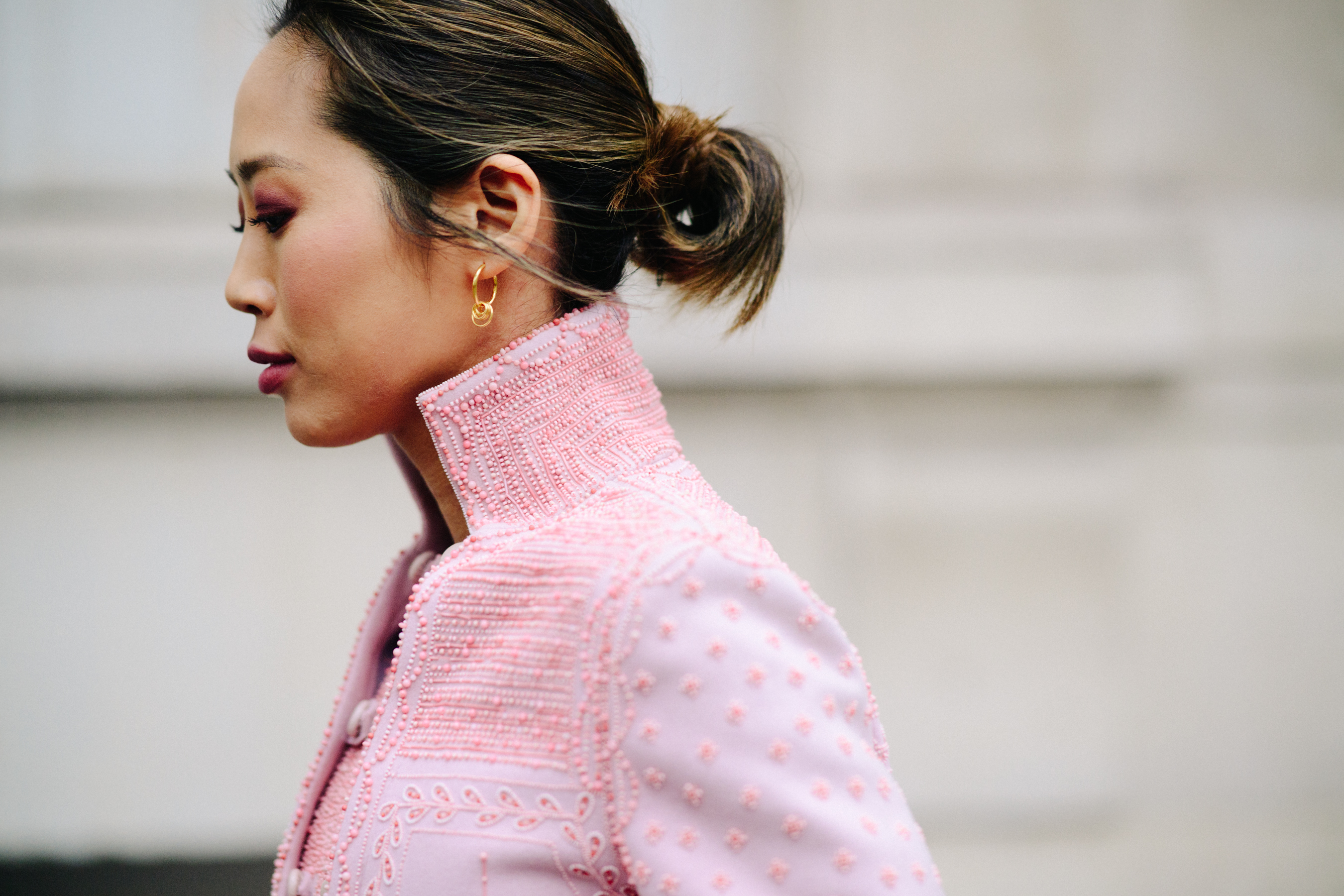 Woman wearing pink embroidered jacket