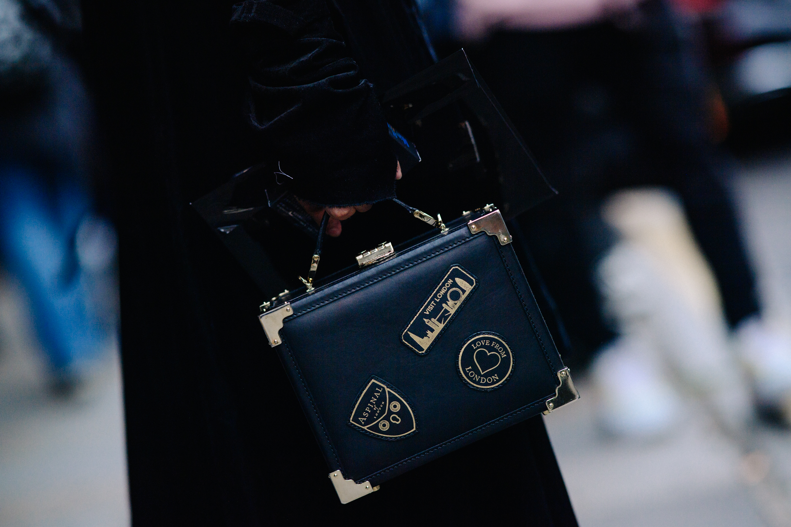 Woman holding bag with London logos